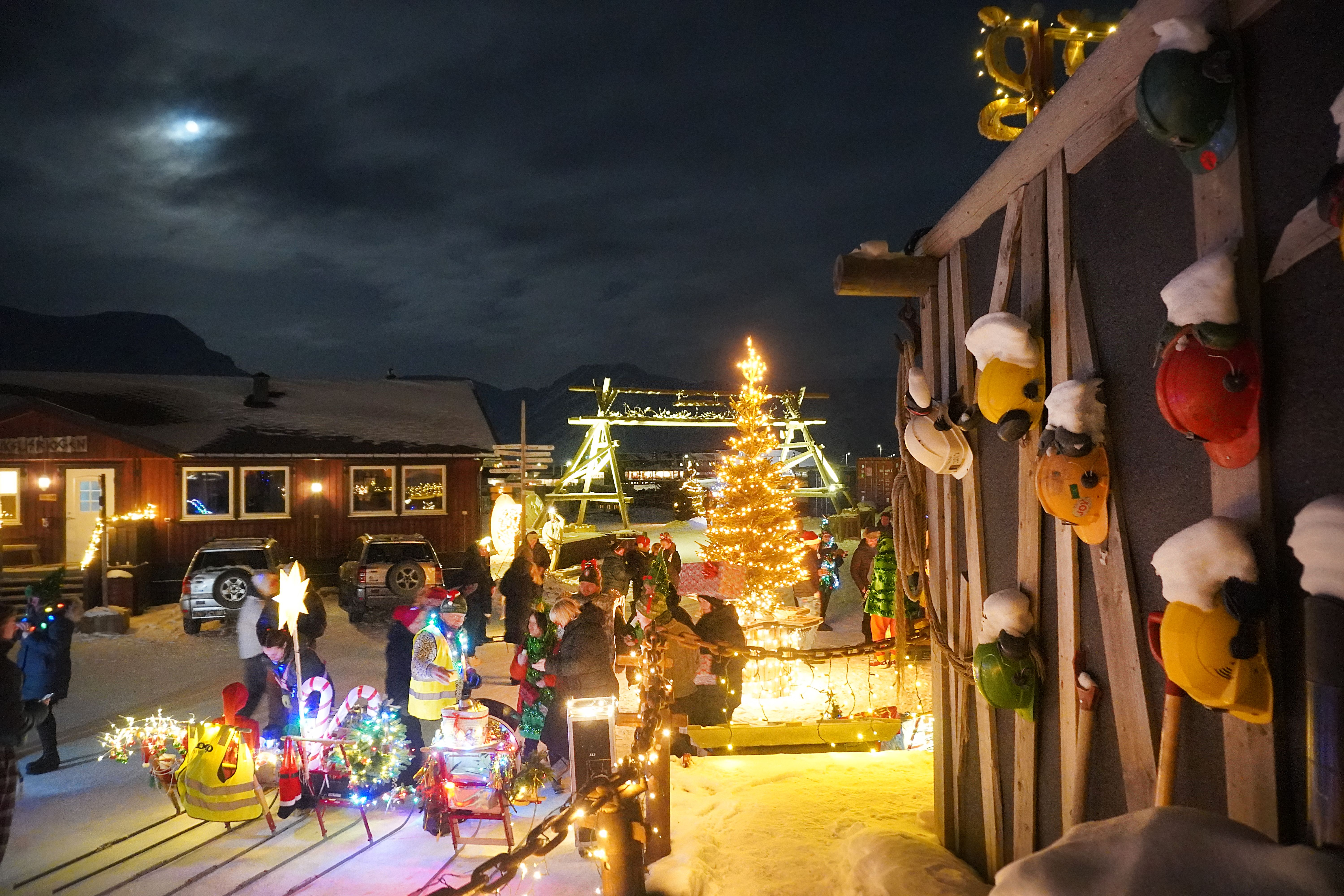 Christmas tree and decorations outside a building with mining helmets
