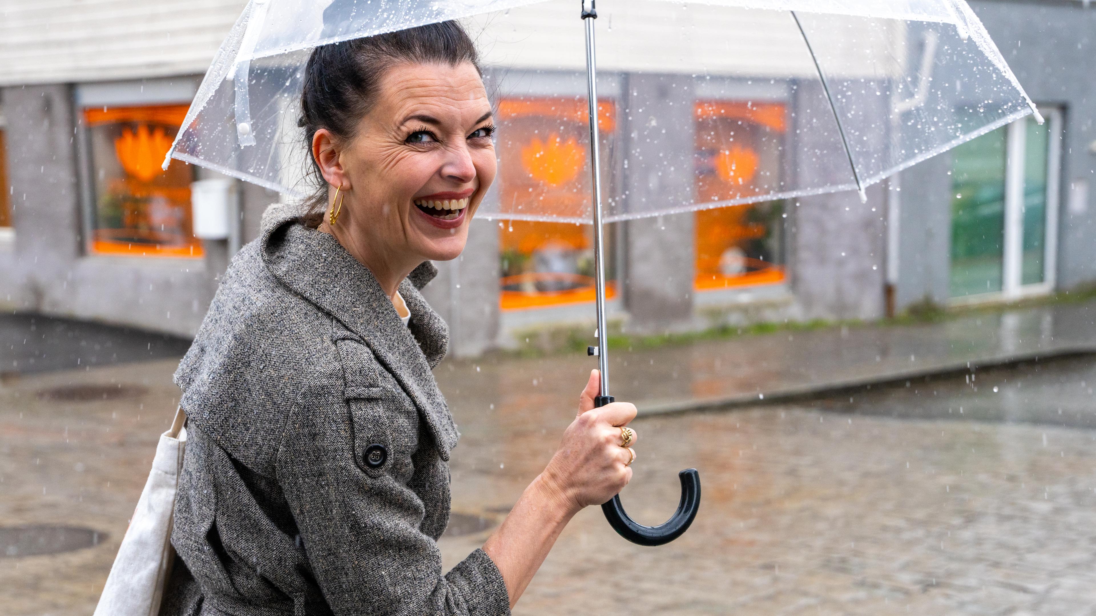 Katrine Lilleland walks in the rain in the streets of Stavanger, Fjord Norway