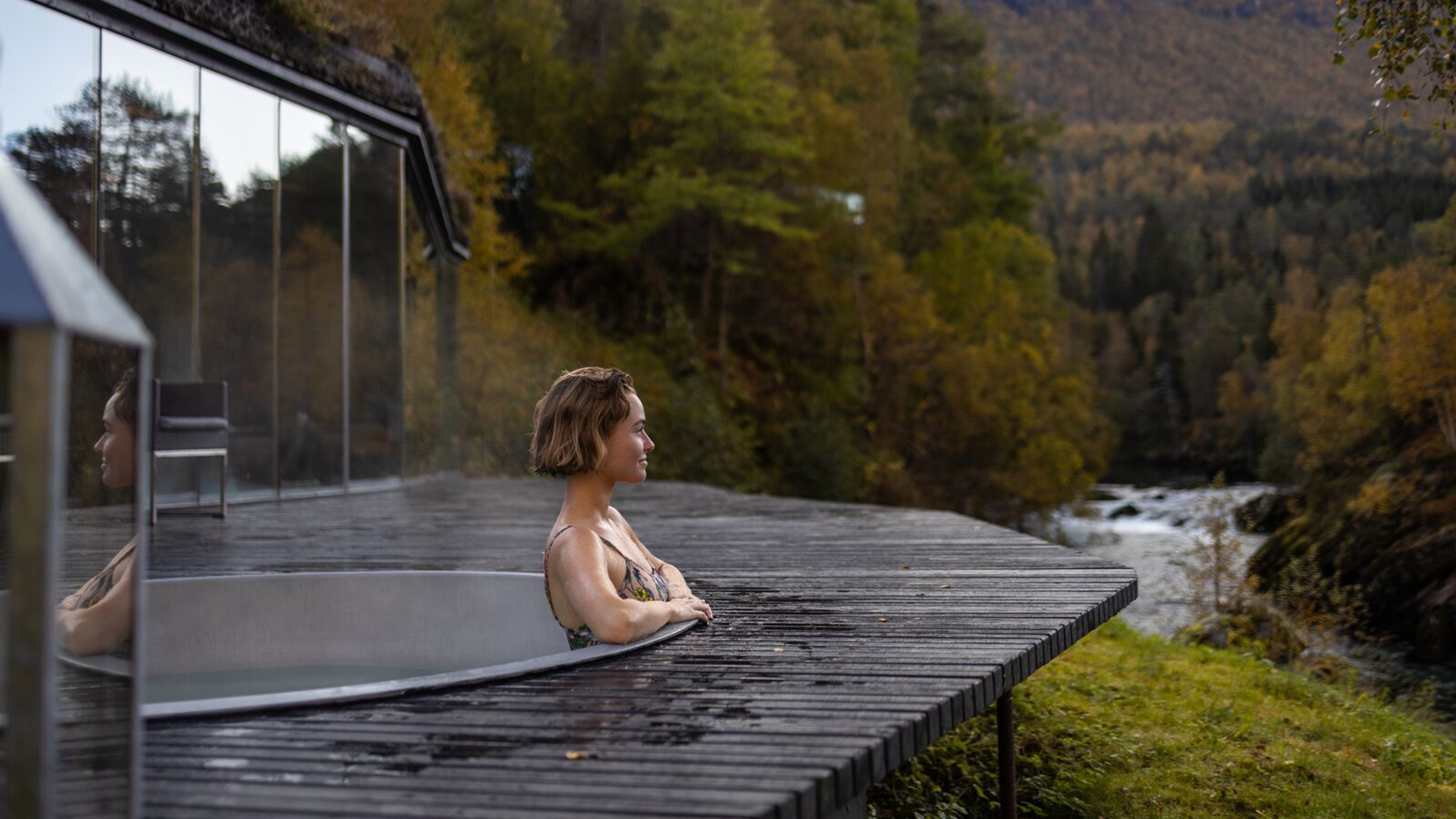 A women enjoying a bath in the spa area at Juvet Landskapshotell, Norway.