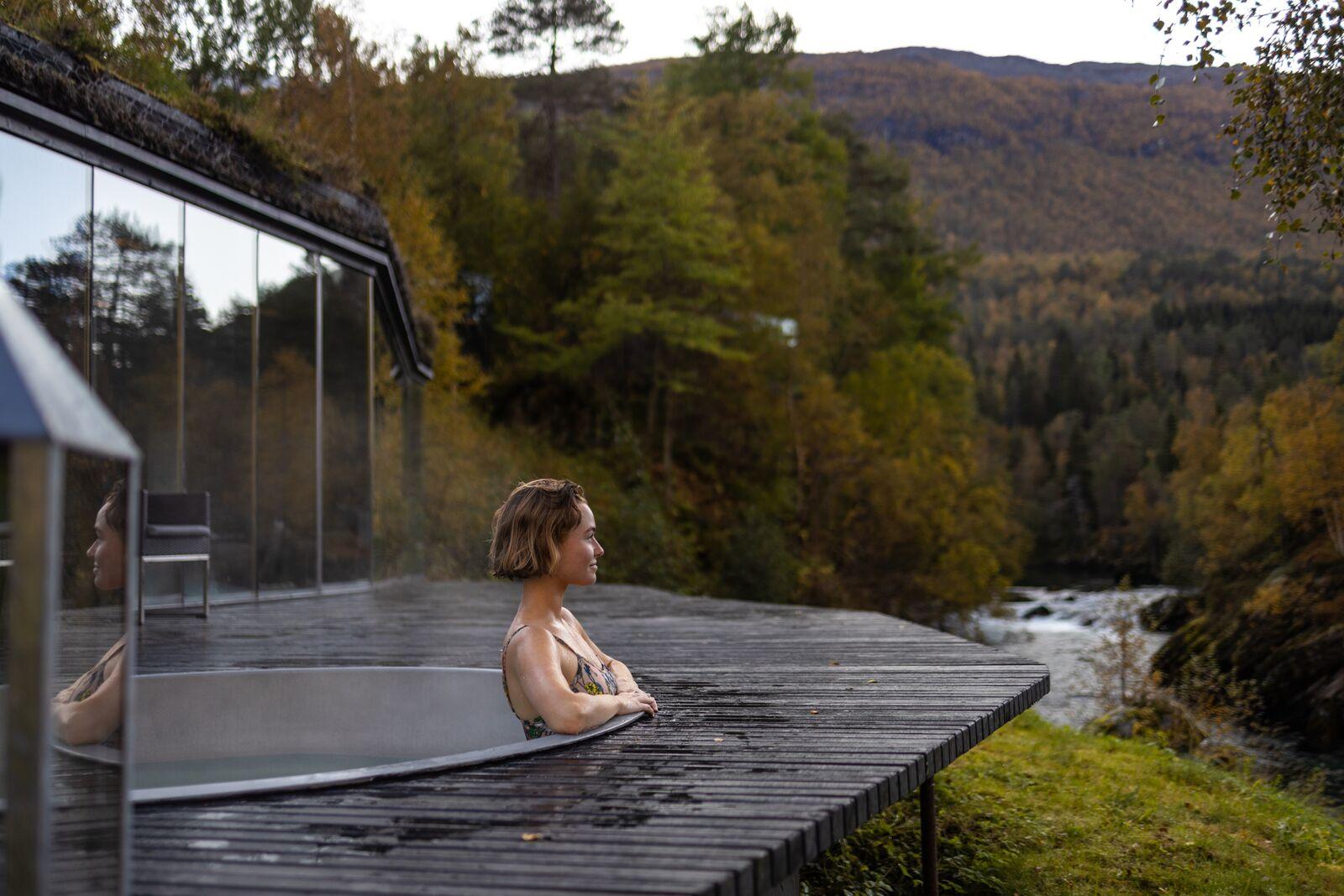 A women enjoying a bath in the spa area at Juvet Landskapshotell, Norway.