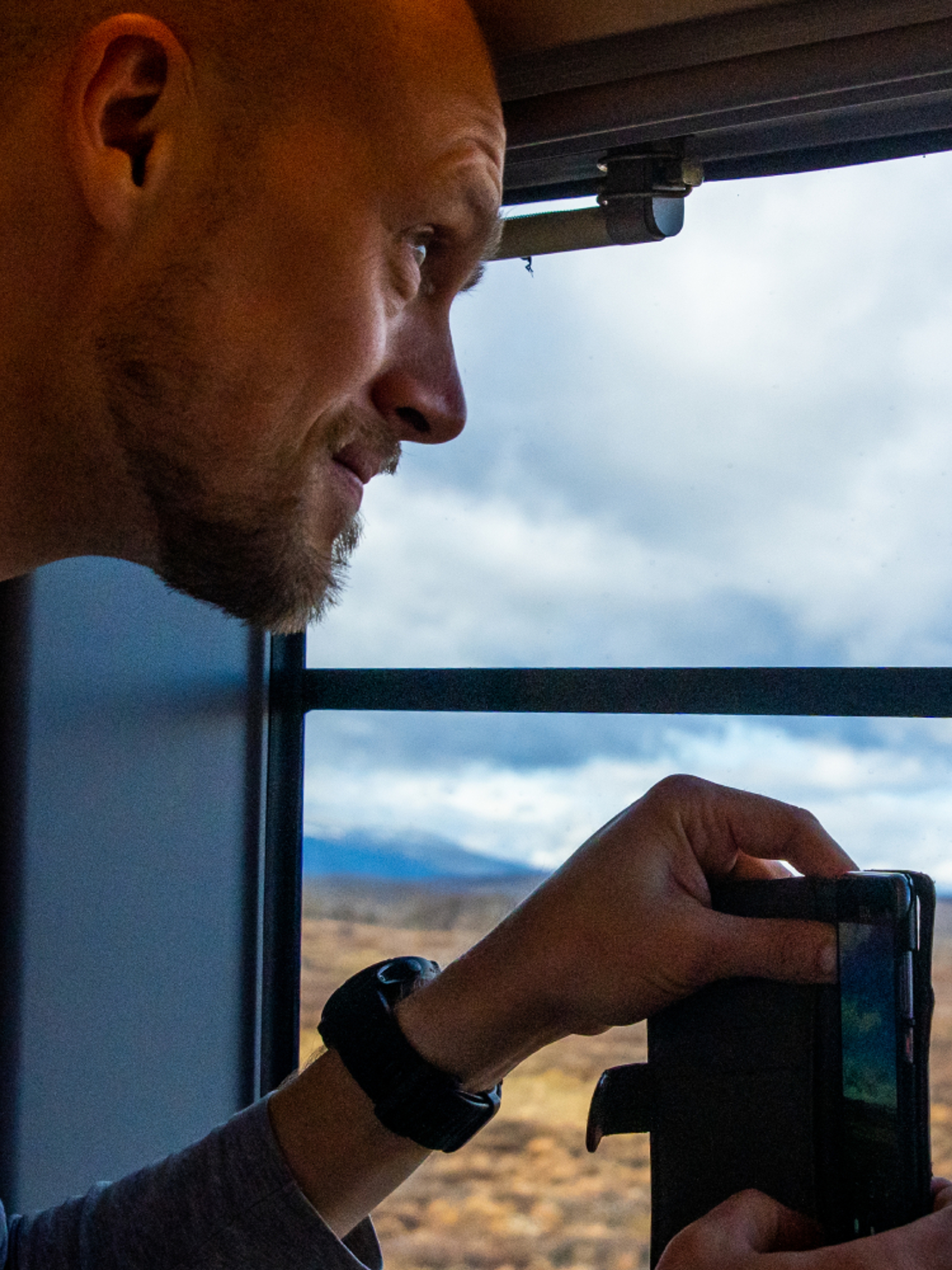 A man taking a picture at the Dovrefjell mountain on the Dovre Railway