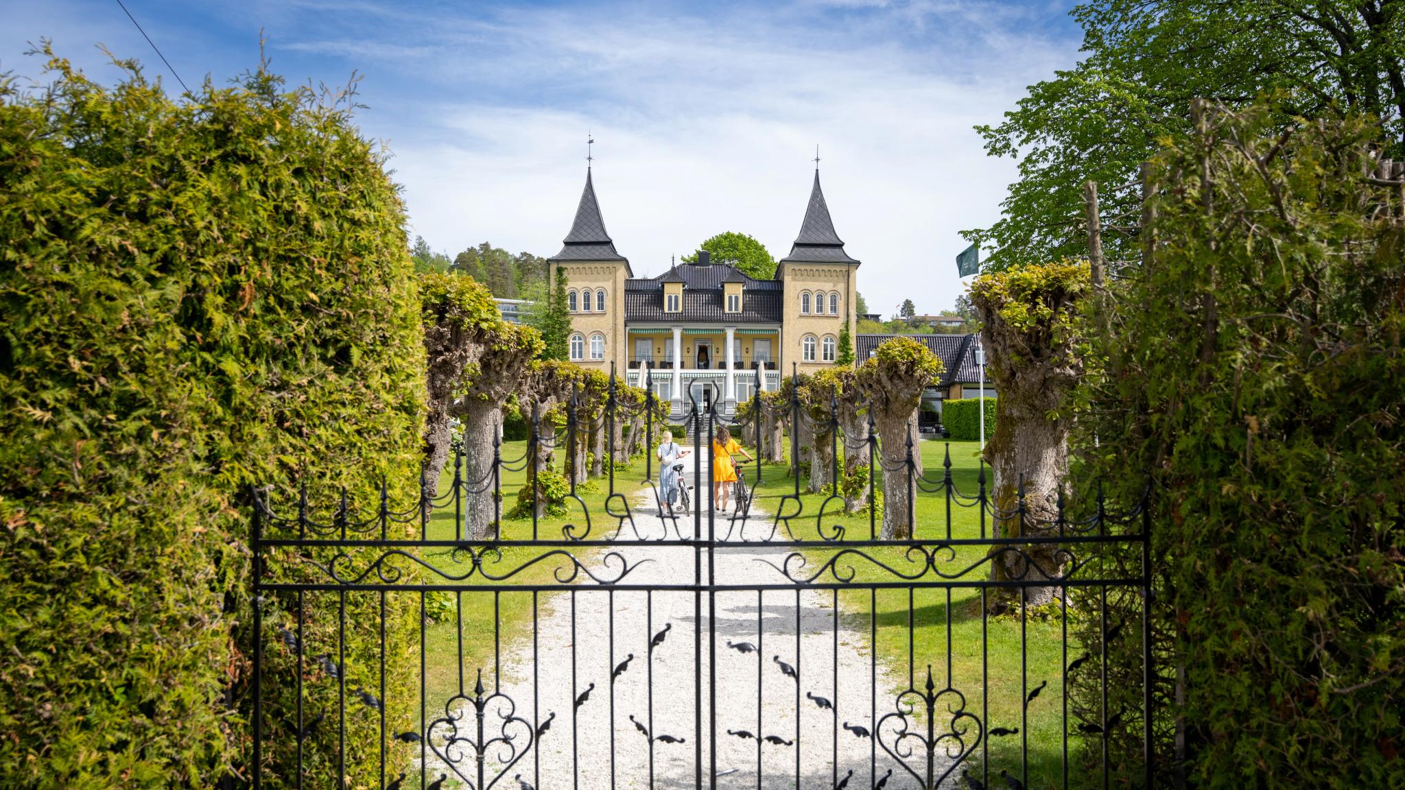 Two women walking up the alley to Refsnes Gods at the Jeløy peninsula in Moss