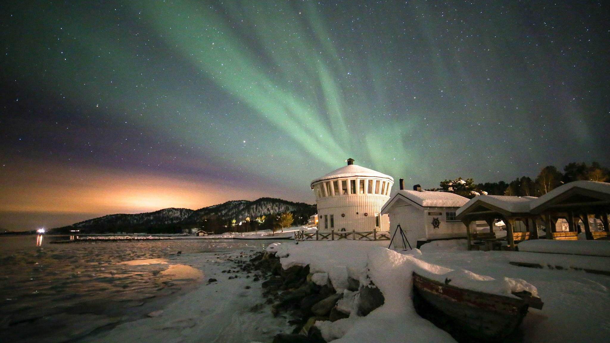Northern lights over The Lighthouse in Senja