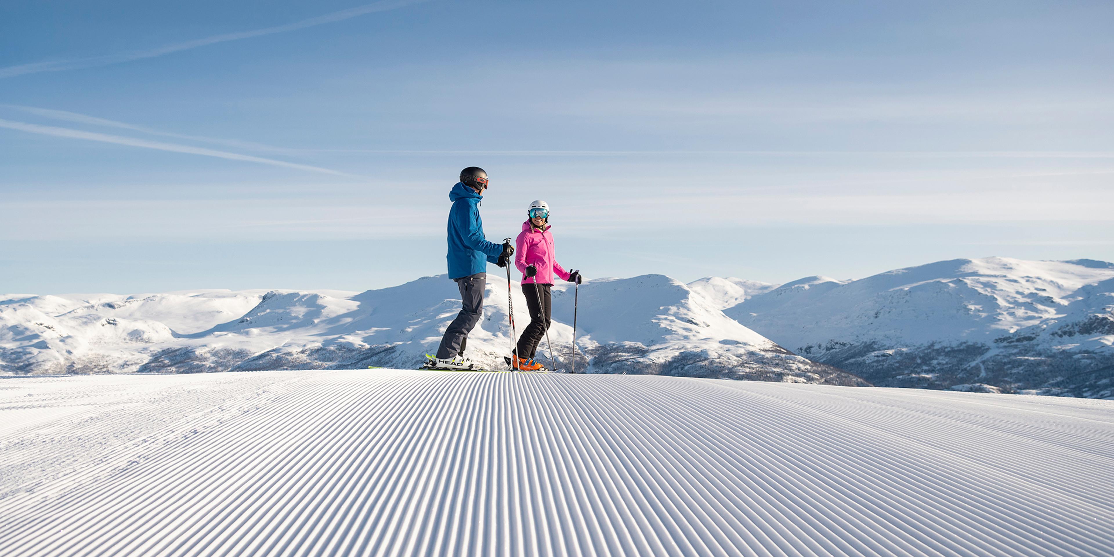 Two people alpine skiing on a sunny day in Hemsedal, Eastern Norway