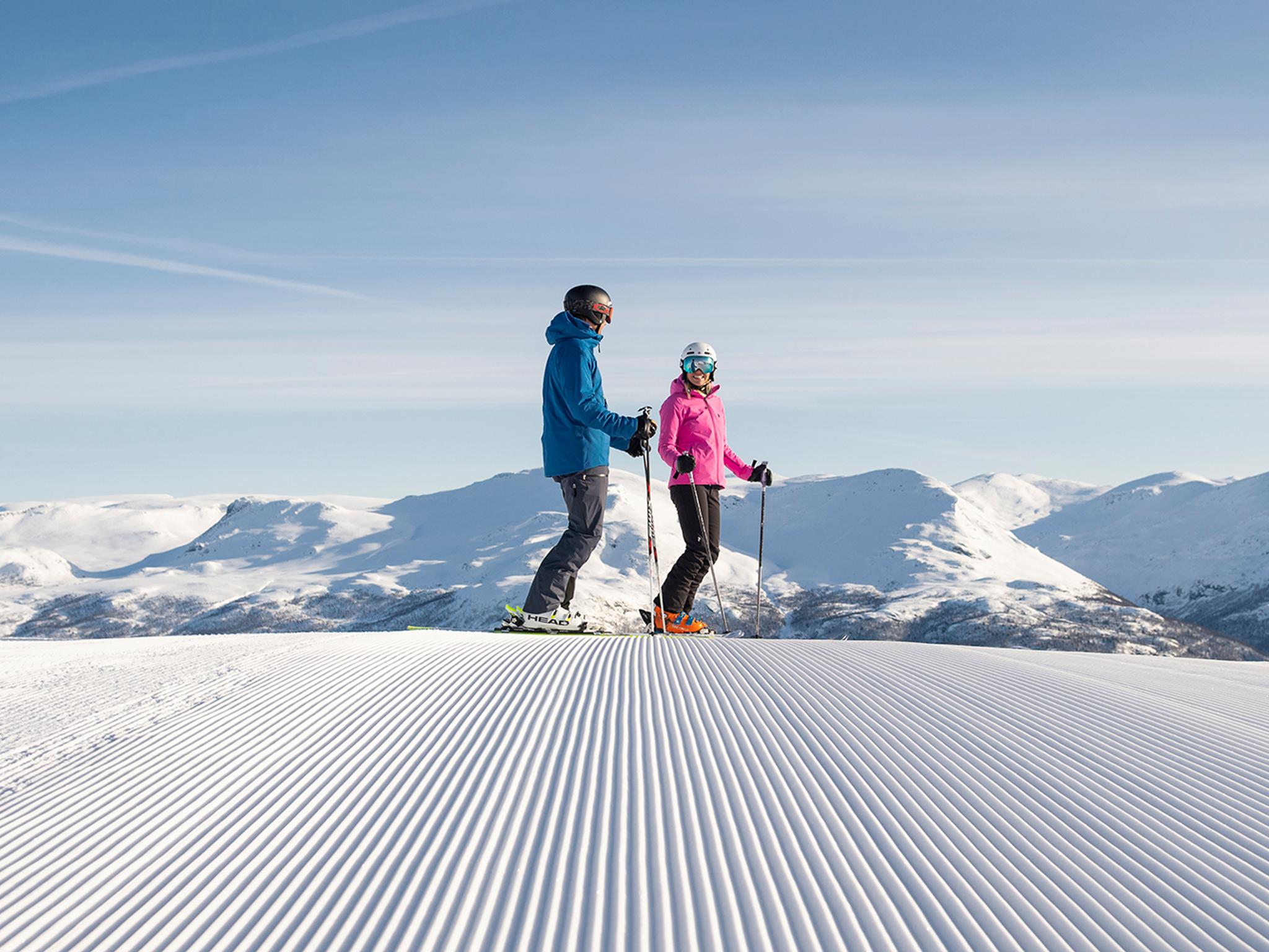 Two people alpine skiing on a sunny day in Hemsedal, Eastern Norway