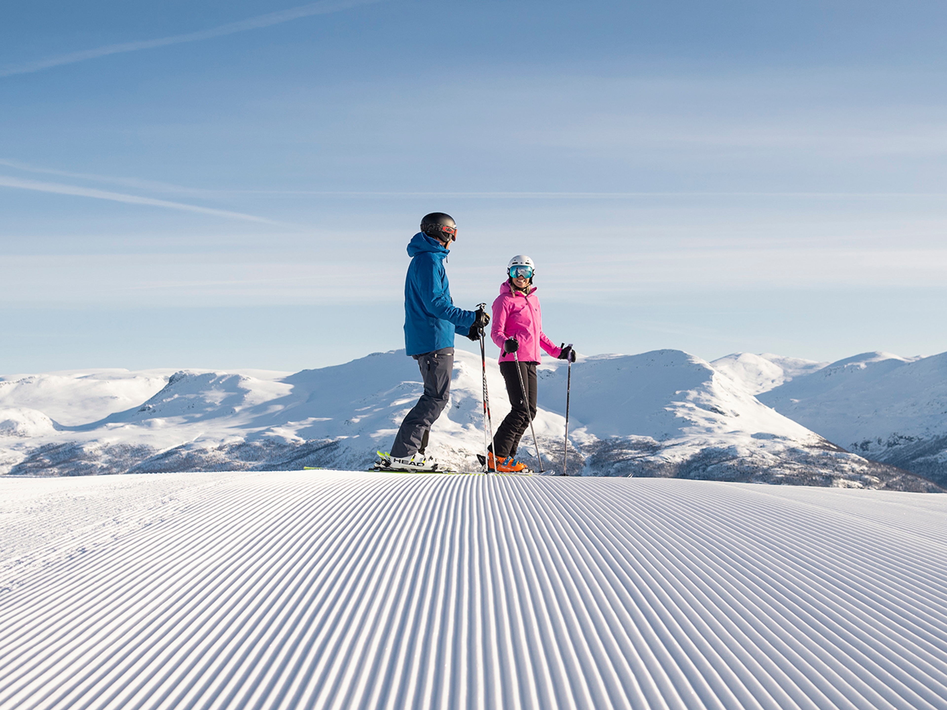 Two people alpine skiing on a sunny day in Hemsedal, Eastern Norway