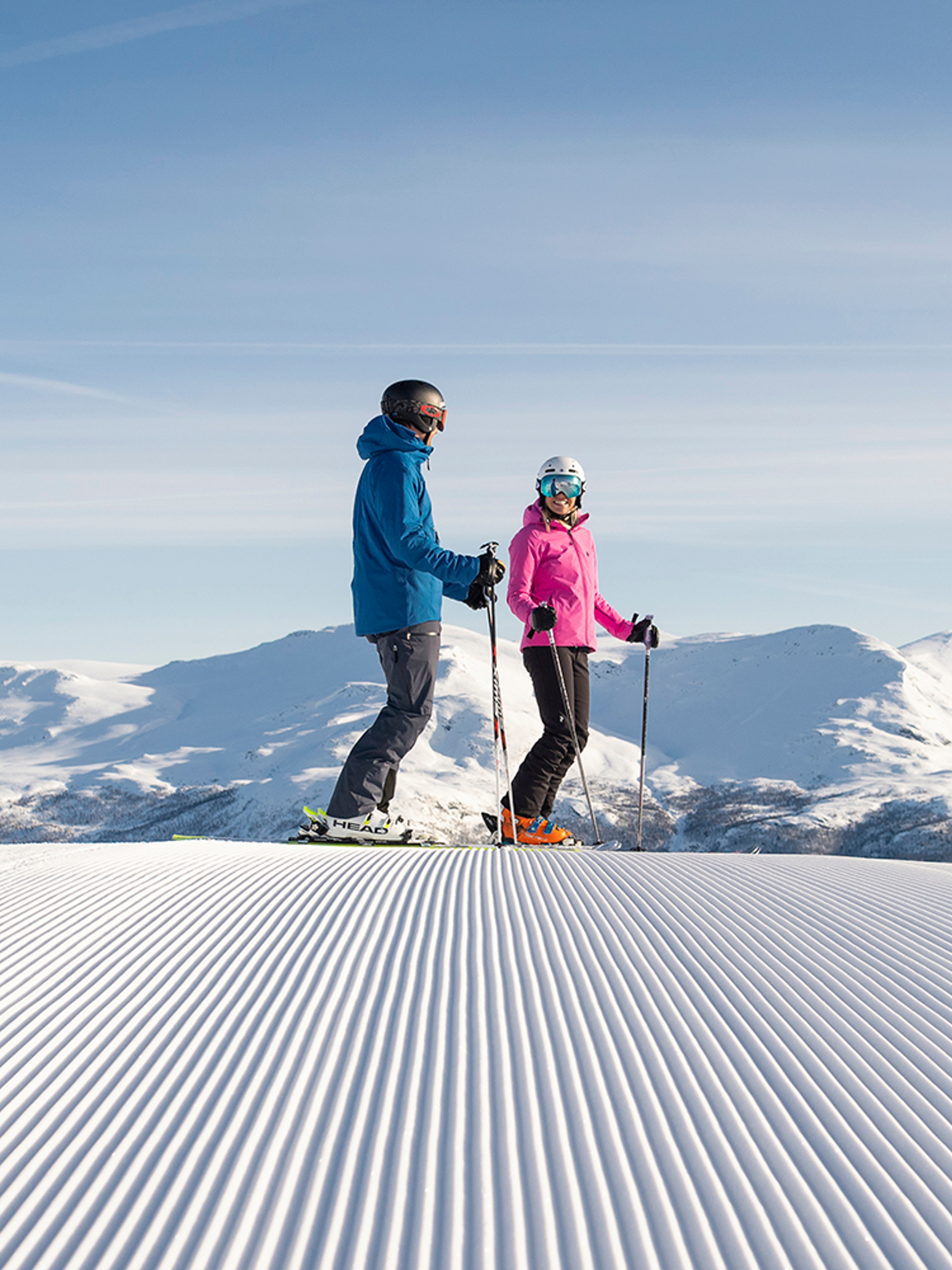 Two people alpine skiing on a sunny day in Hemsedal, Eastern Norway