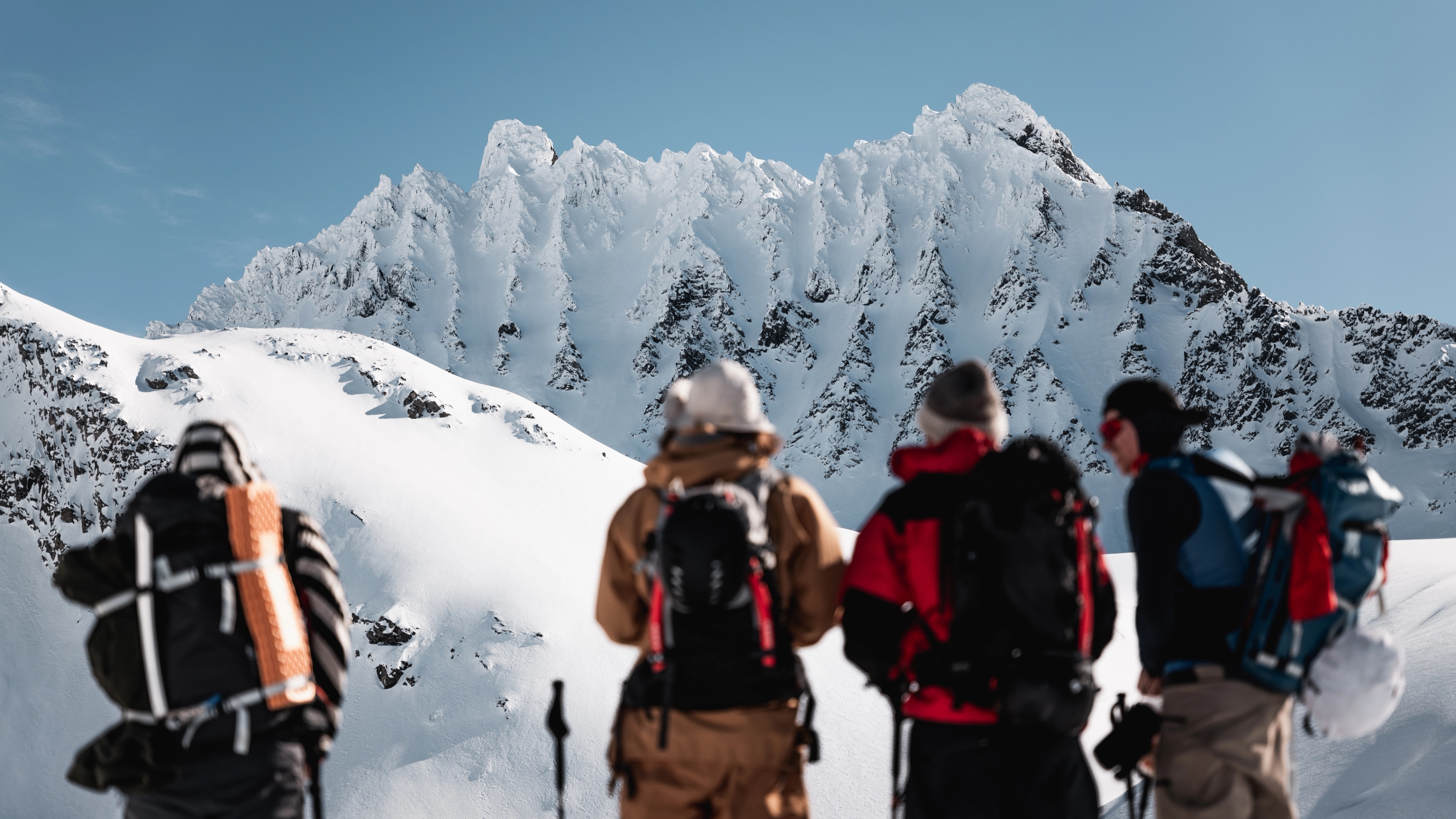 A group of people ski touring to Smørskredtindane in the Sunnmøre alps in Fjord Norway