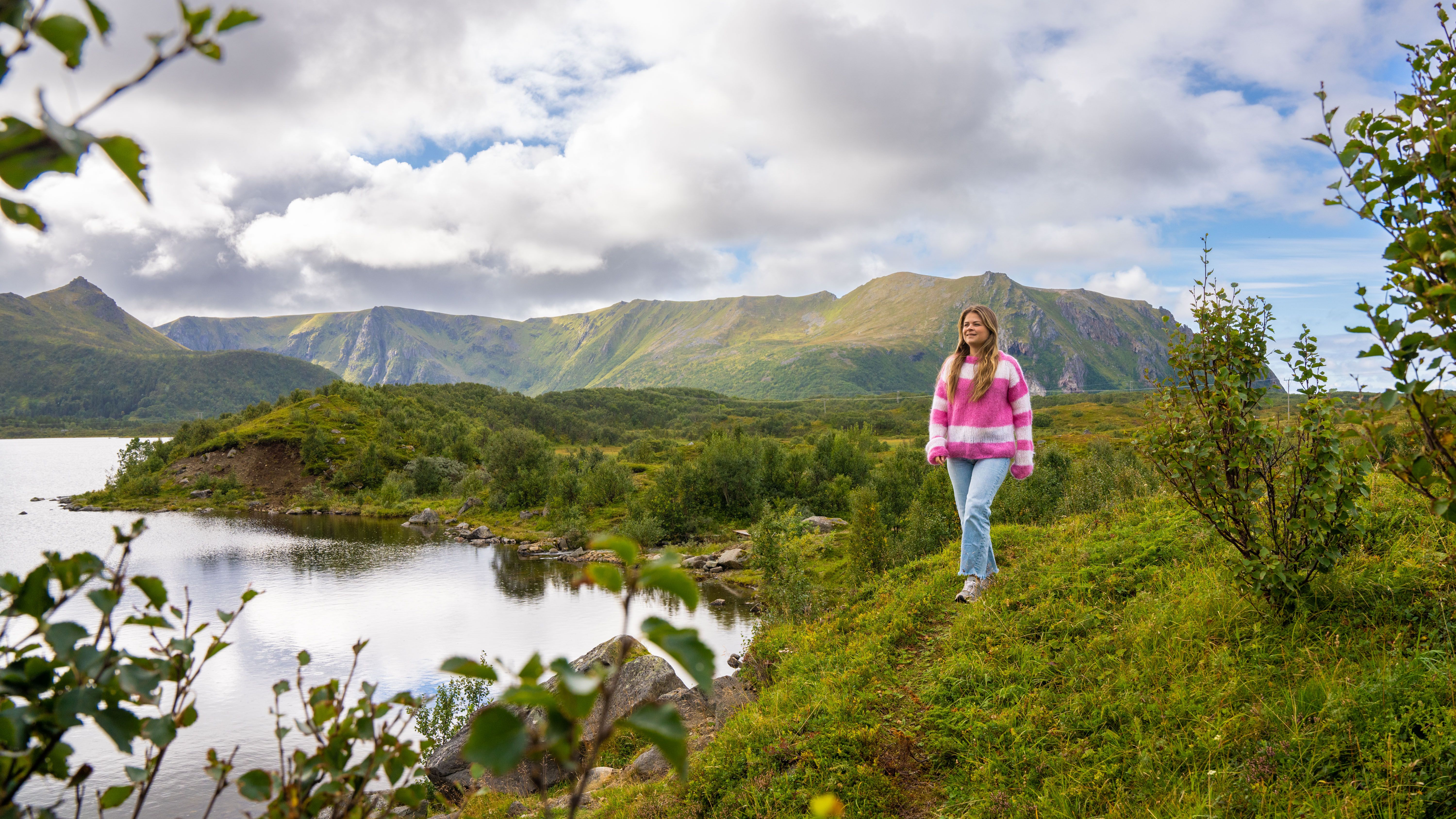 A woman hiking on the coastal trail between Stave and Bleik on Andøya