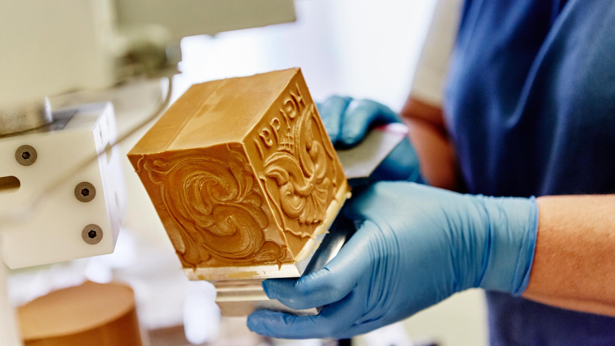 A person making brown cheese at the Norwegian creamery Heidal Ysteri in the Gudbrandsdalen valley of Eastern Norway
