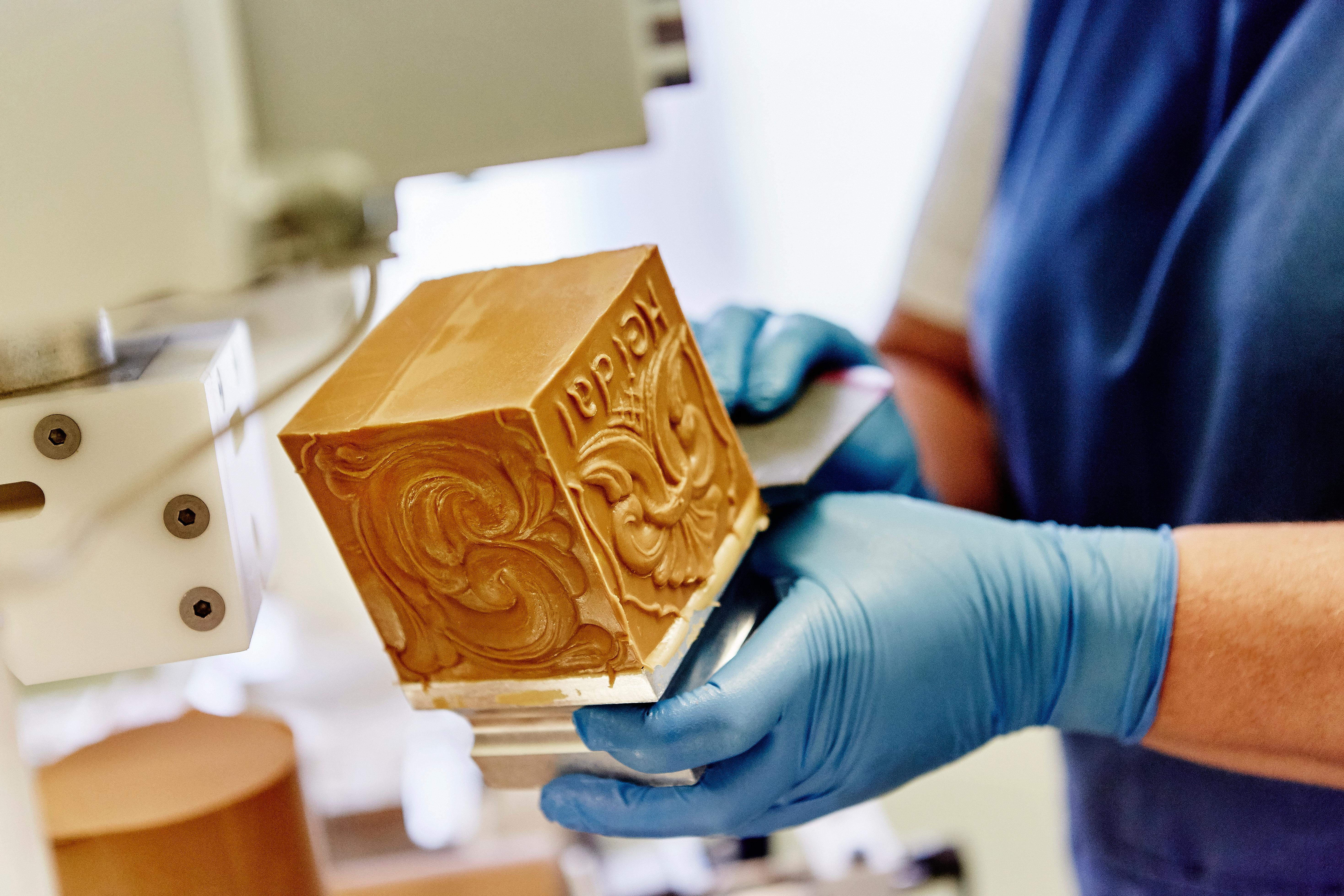 A person making brown cheese at the Norwegian creamery Heidal Ysteri in the Gudbrandsdalen valley of Eastern Norway