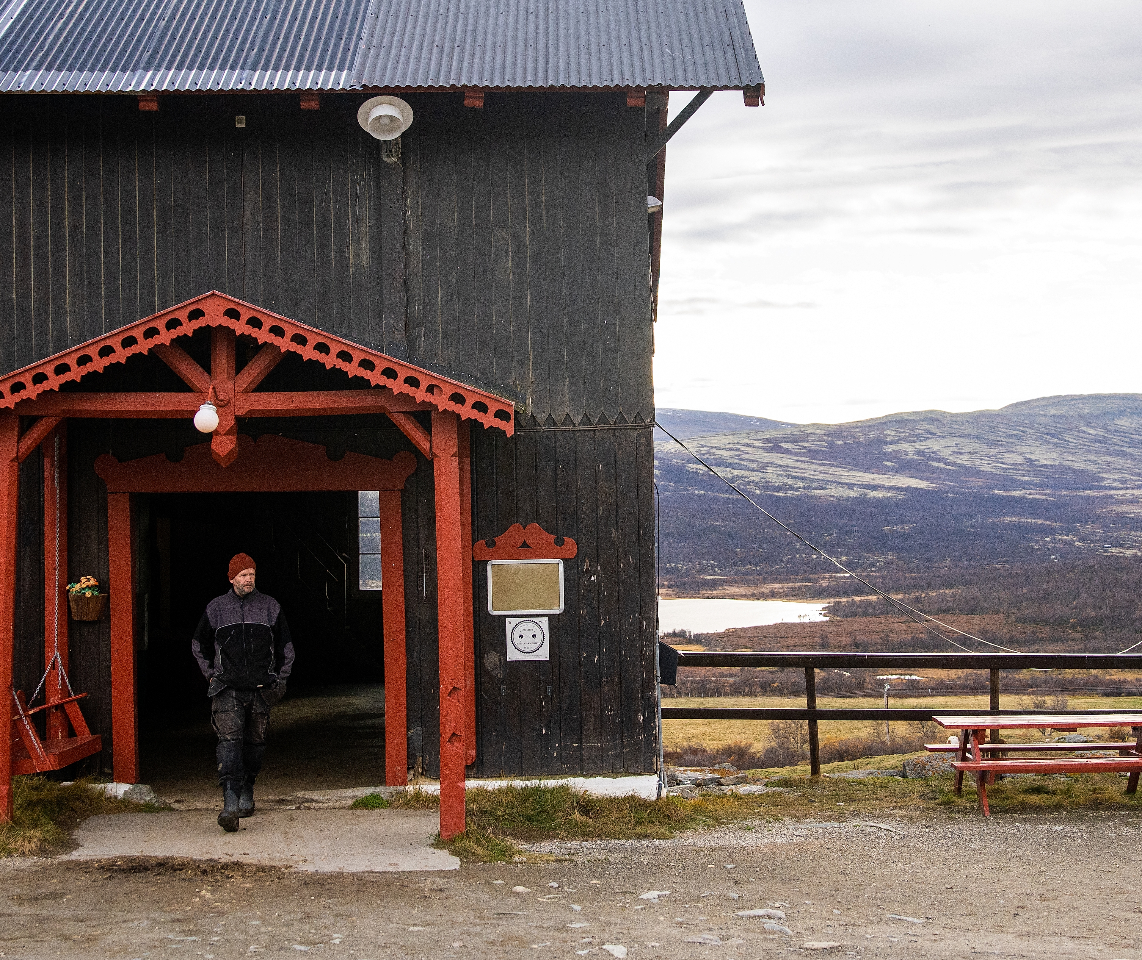 The stable at Hjerkinn Fjellstue, mountain lodge, with mountains in the background.