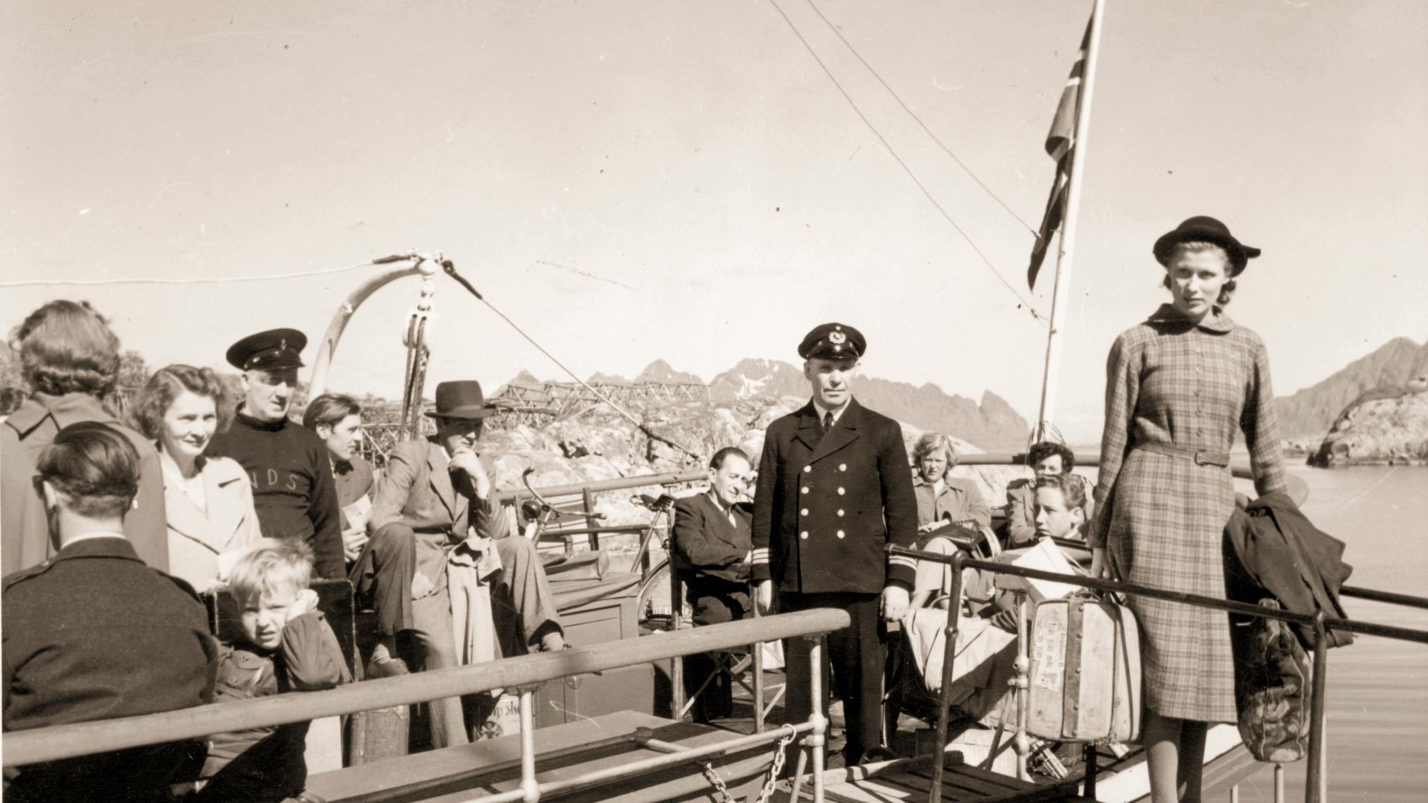 A black and white photo of a woman embarking from a Hurtigruten ship in Norway