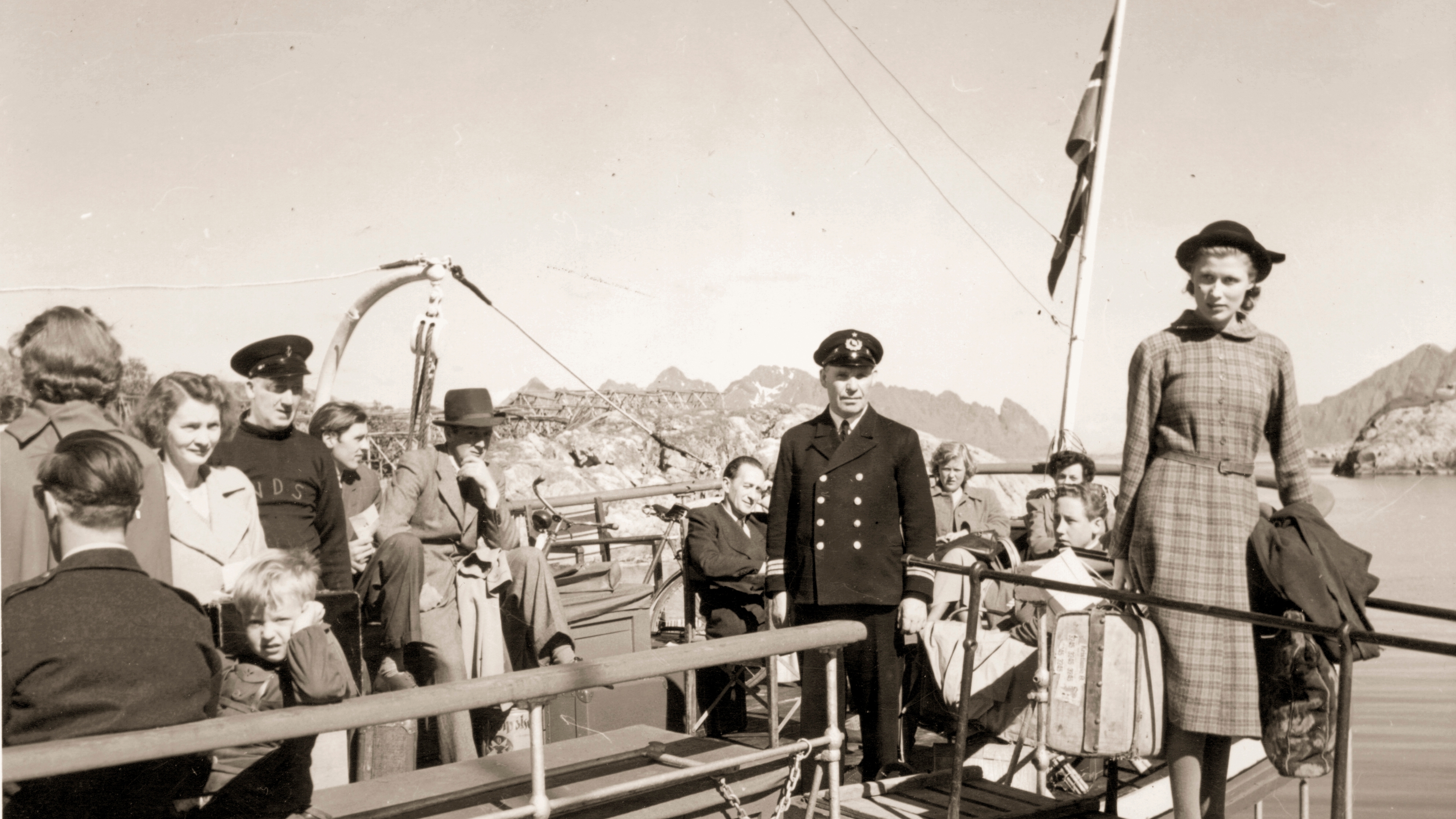 A black and white photo of a woman embarking from a Hurtigruten ship in Norway