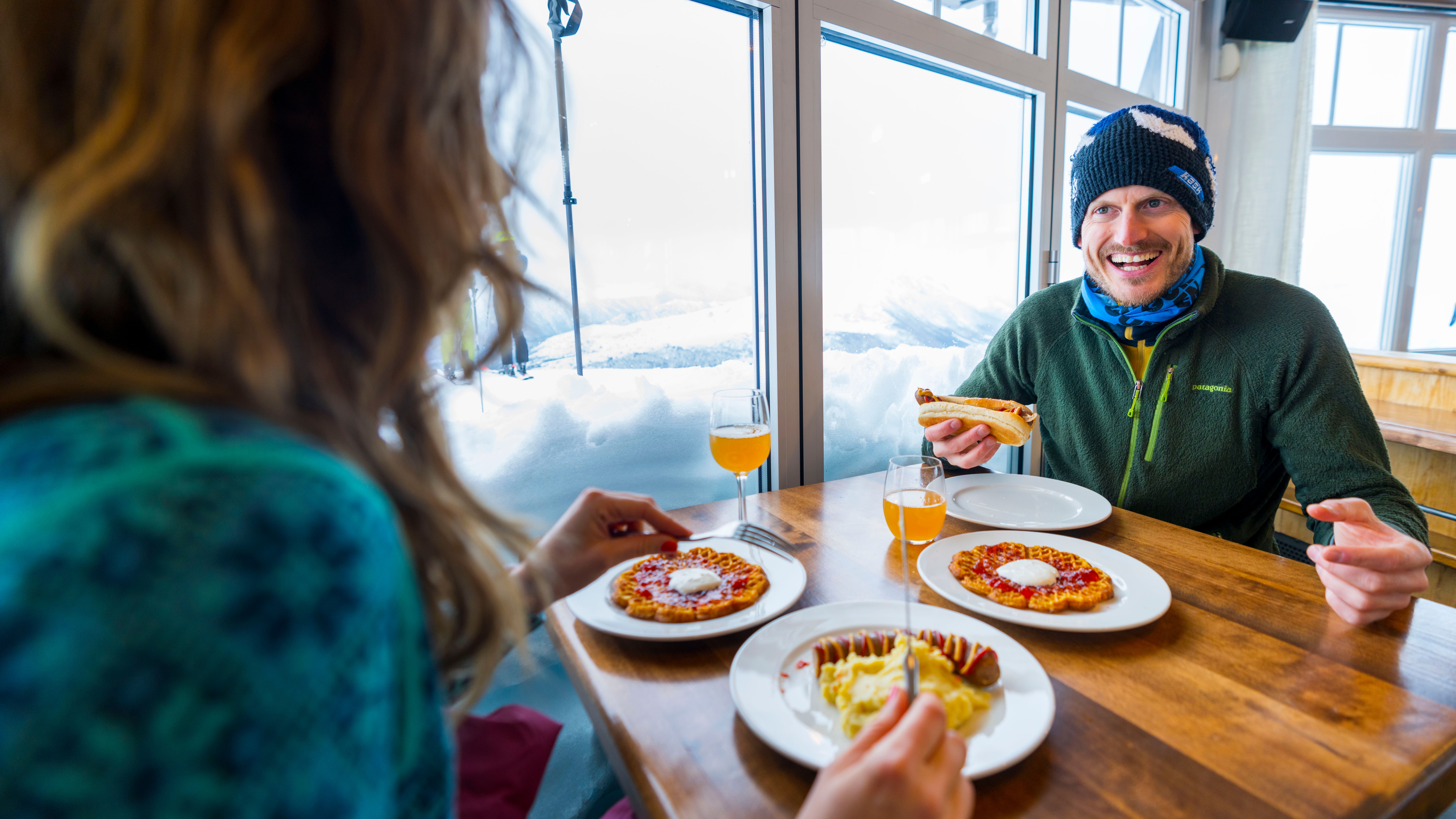 Two people eating food at restaurant Fjord Panorama in Stranda ski resort