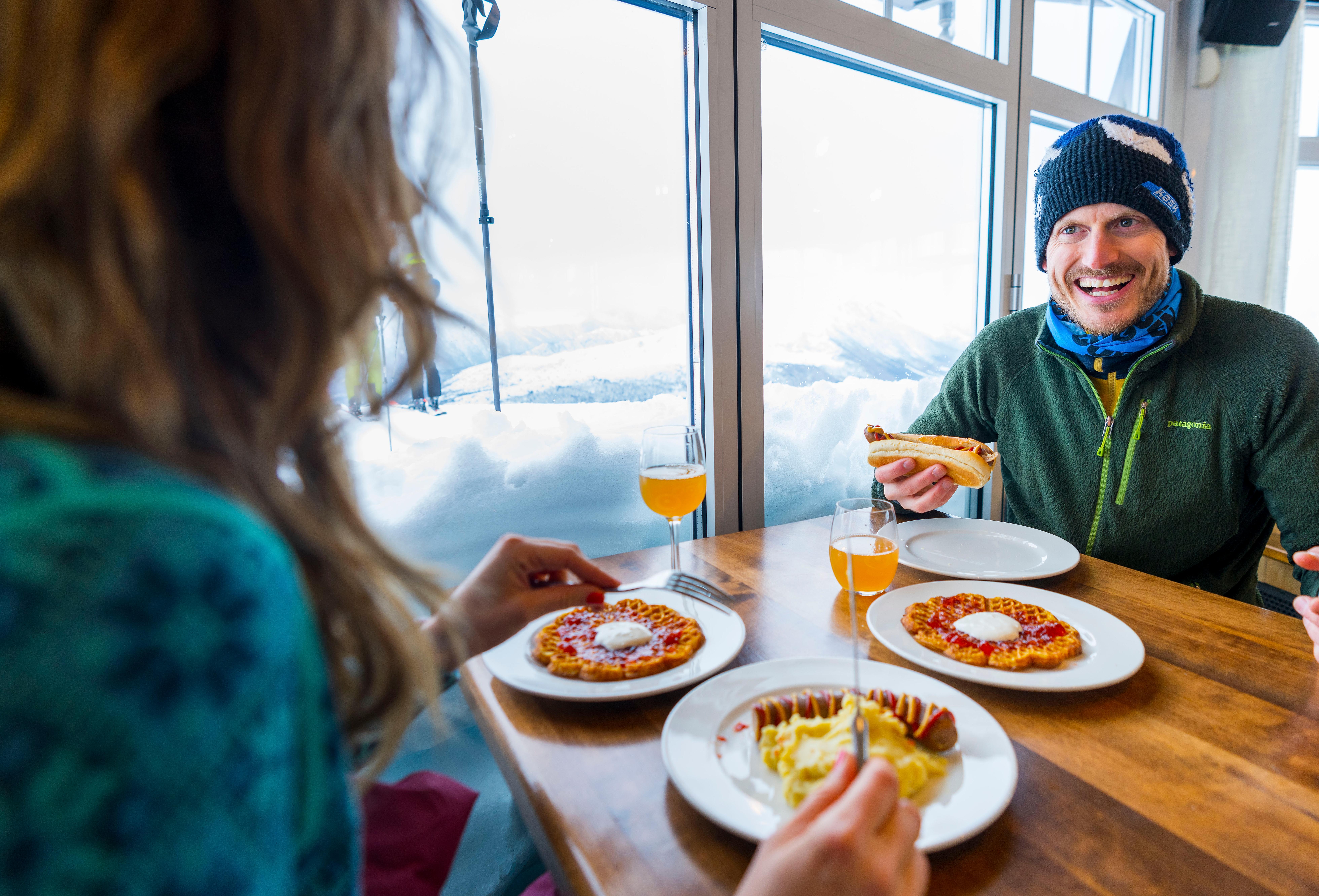 Two people eating food at restaurant Fjord Panorama in Stranda ski resort
