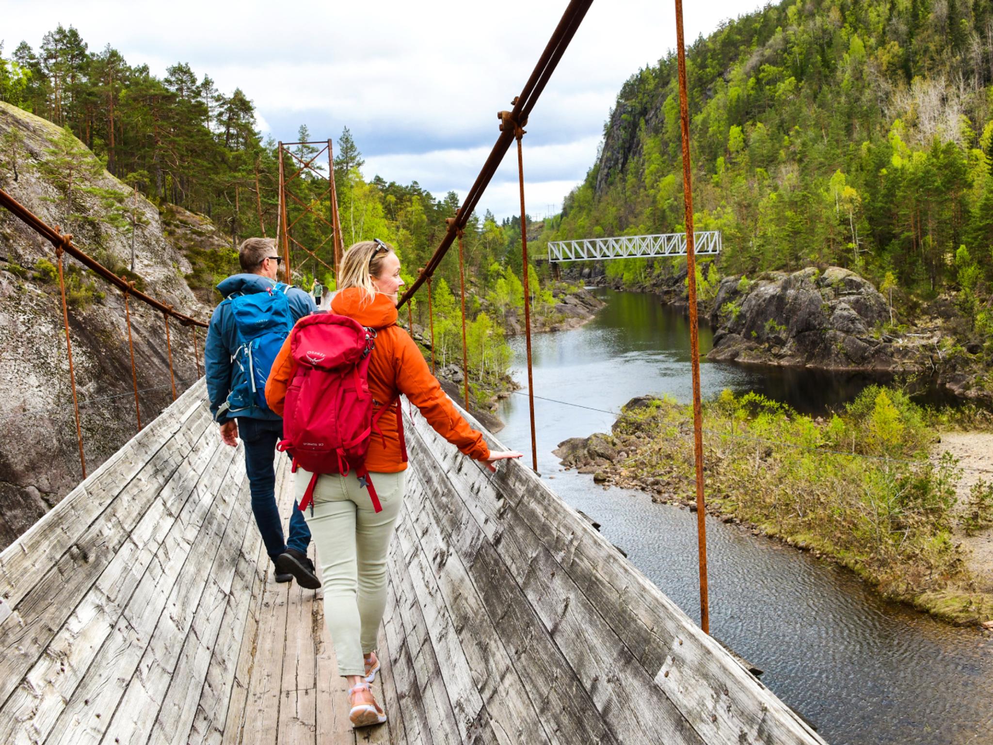 Two people hiking the Tømmerrenna timber slide in Vennesla, Southern Norway