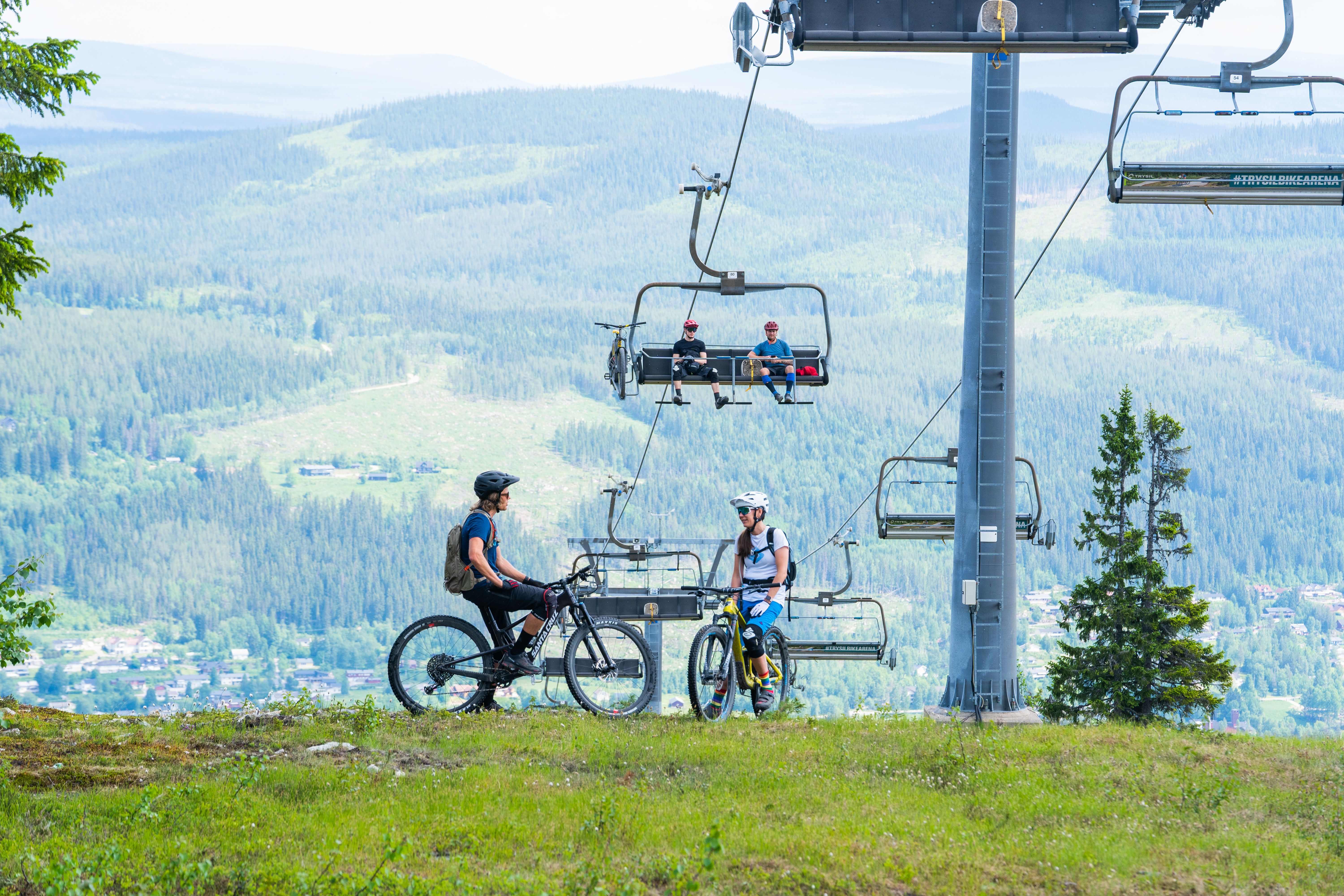 People using ski lifts as bike lifts.