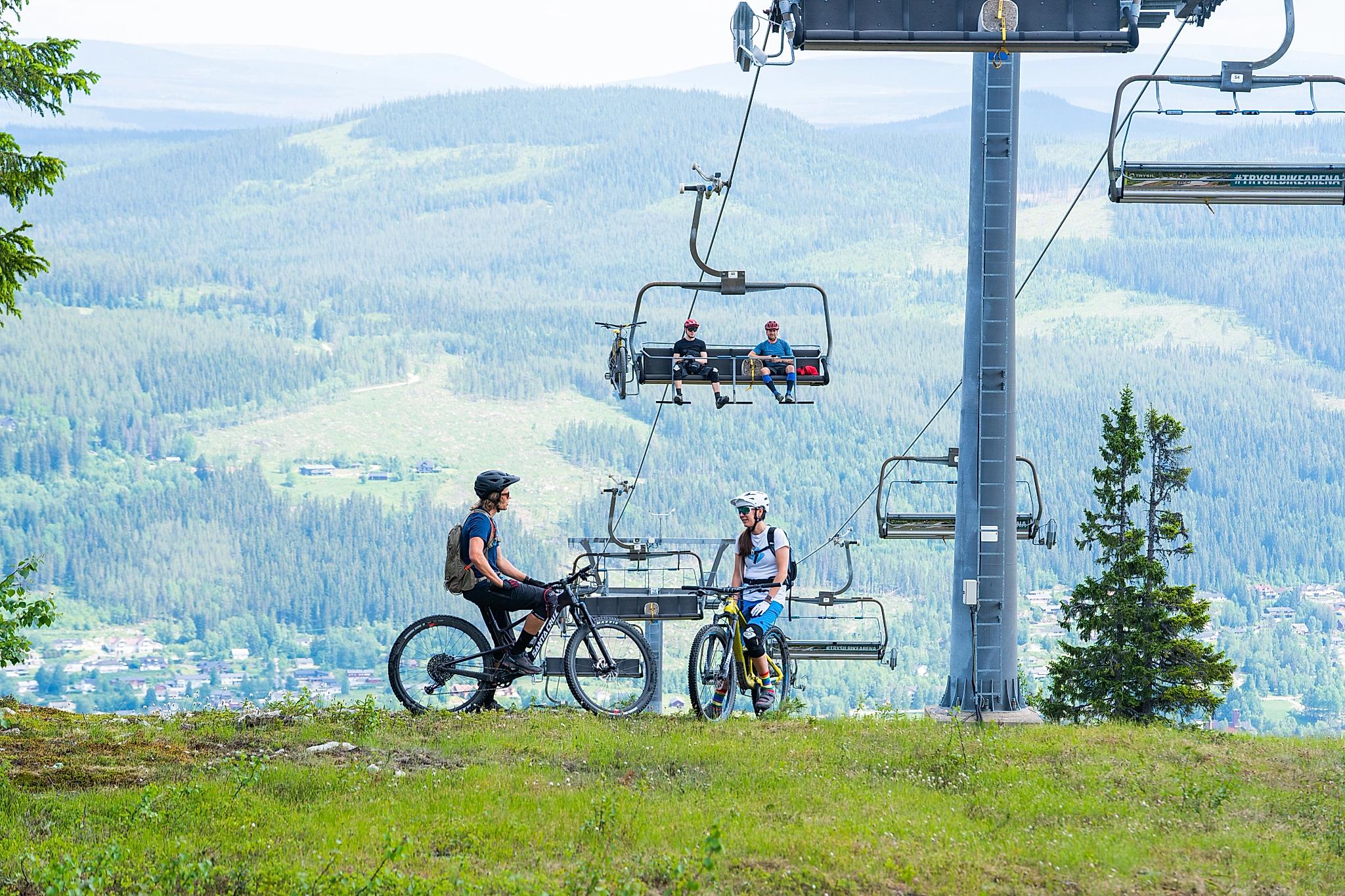 People using ski lifts as bike lifts.