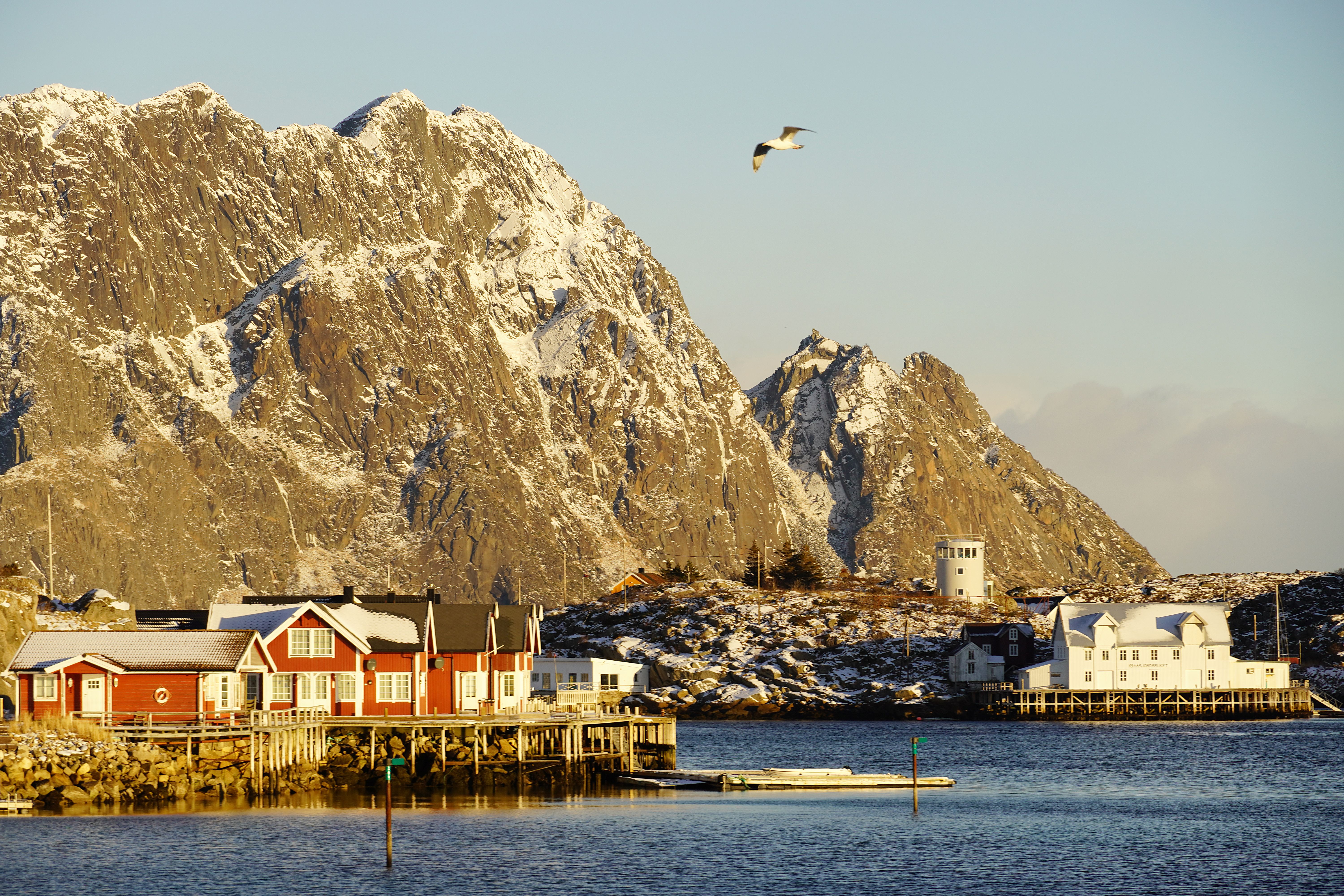 A harbour at the island of Skrova with tall mountains behind
