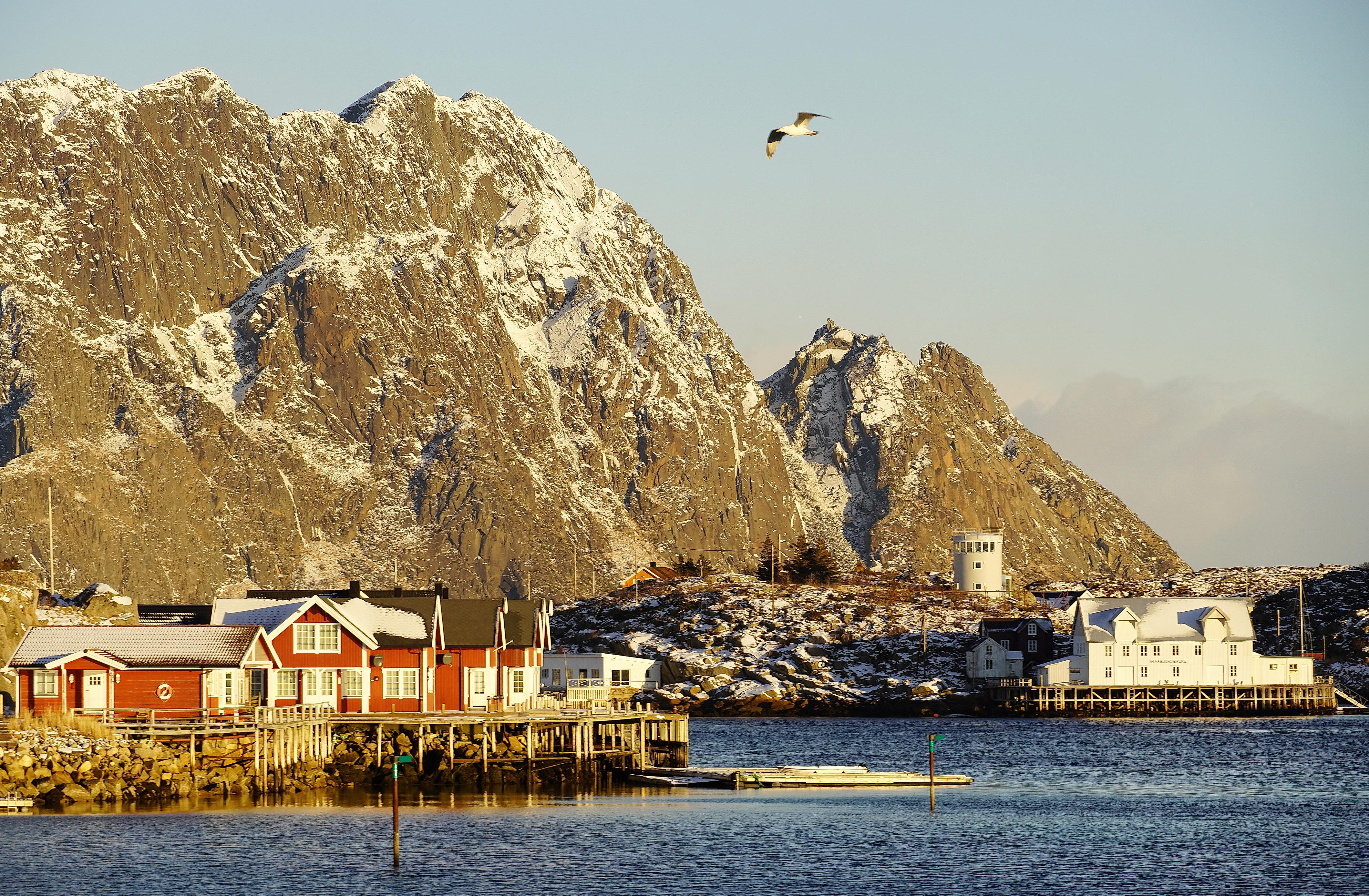 A harbour at the island of Skrova with tall mountains behind