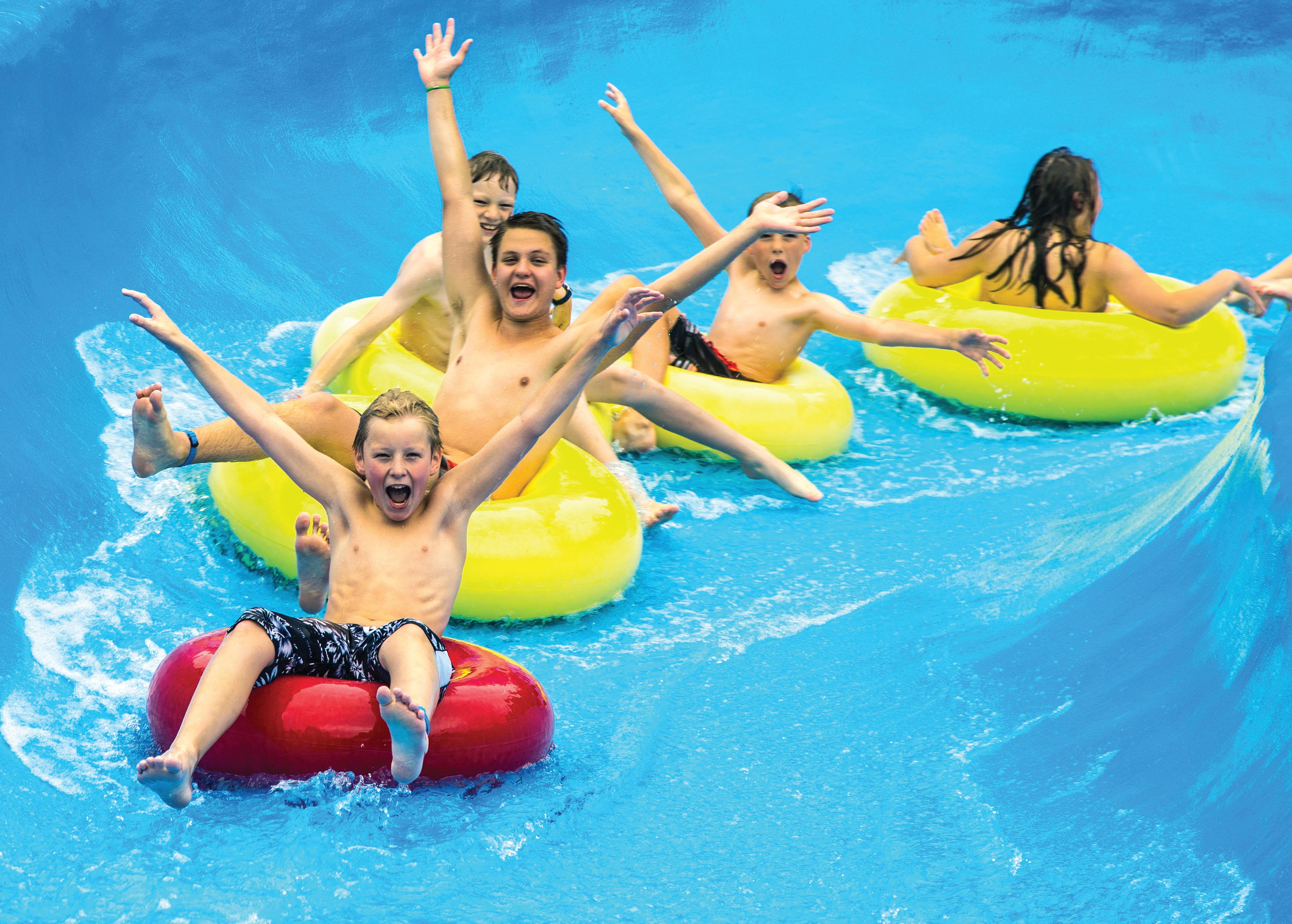 Children having fun sliding down a water slide at Tropicana water park in Gol in Hallingdal, Eastern Norway