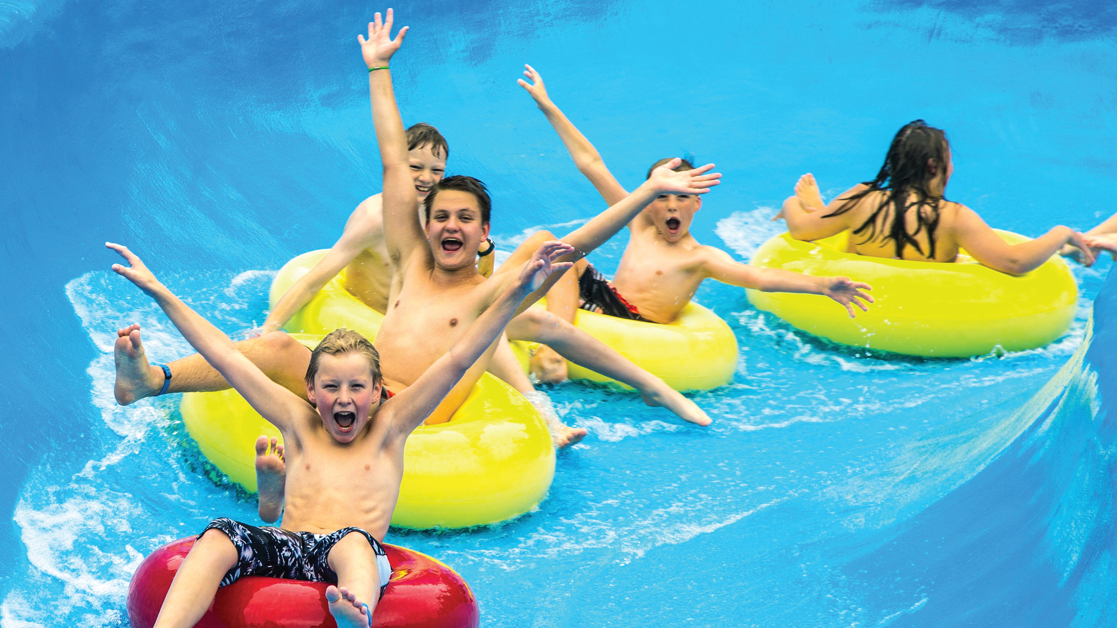 Children having fun sliding down a water slide at Tropicana water park in Gol in Hallingdal, Eastern Norway