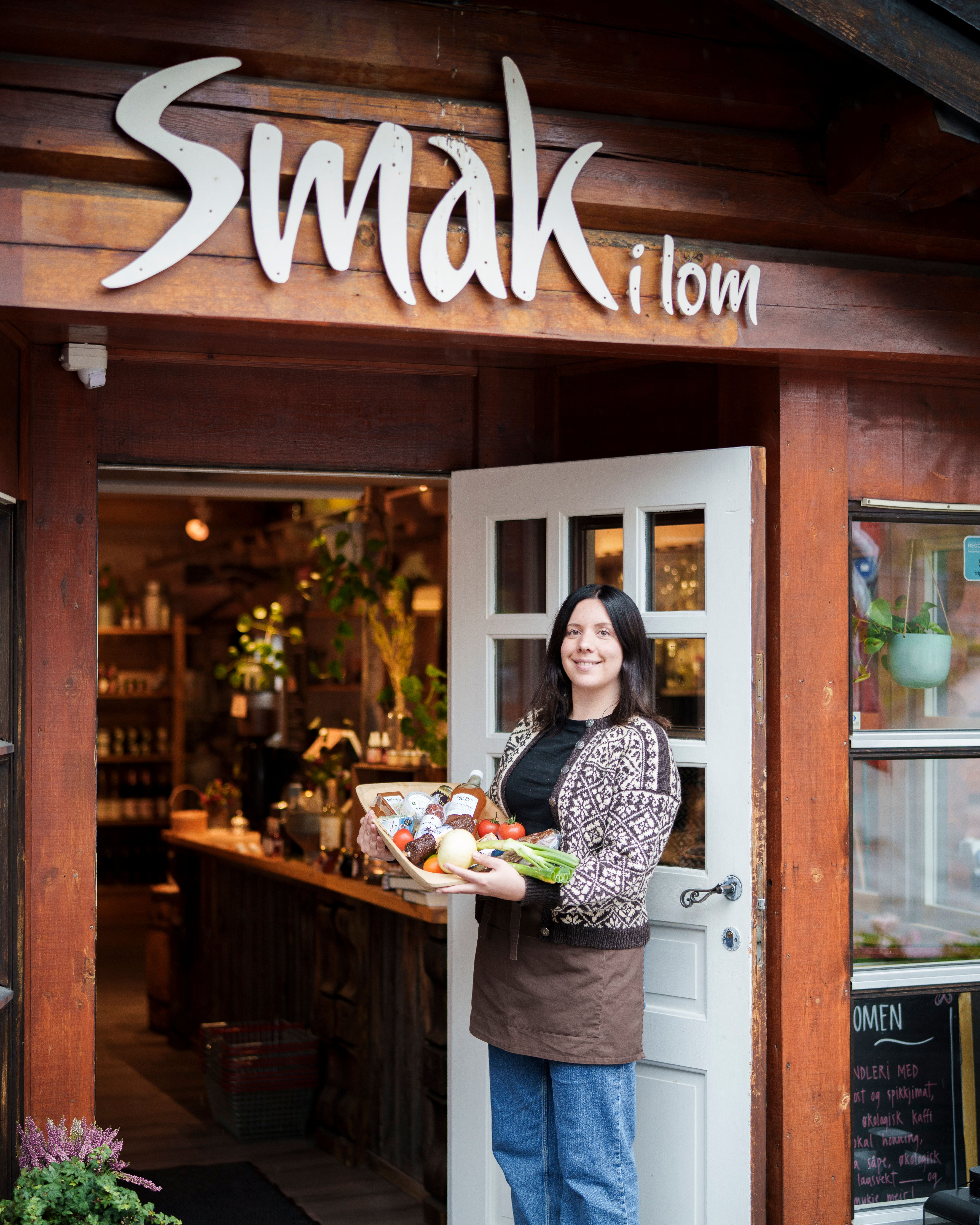 A woman holding a tray with local products.