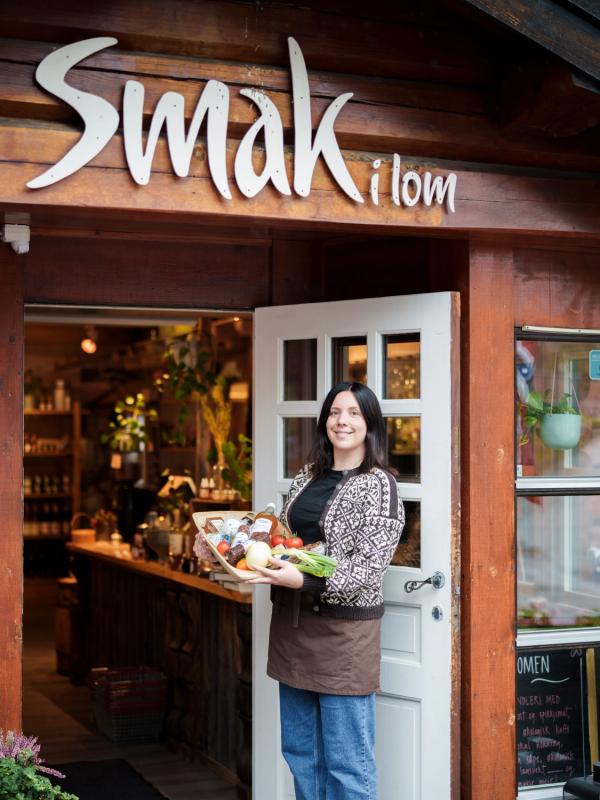 A woman holding a tray with local products.