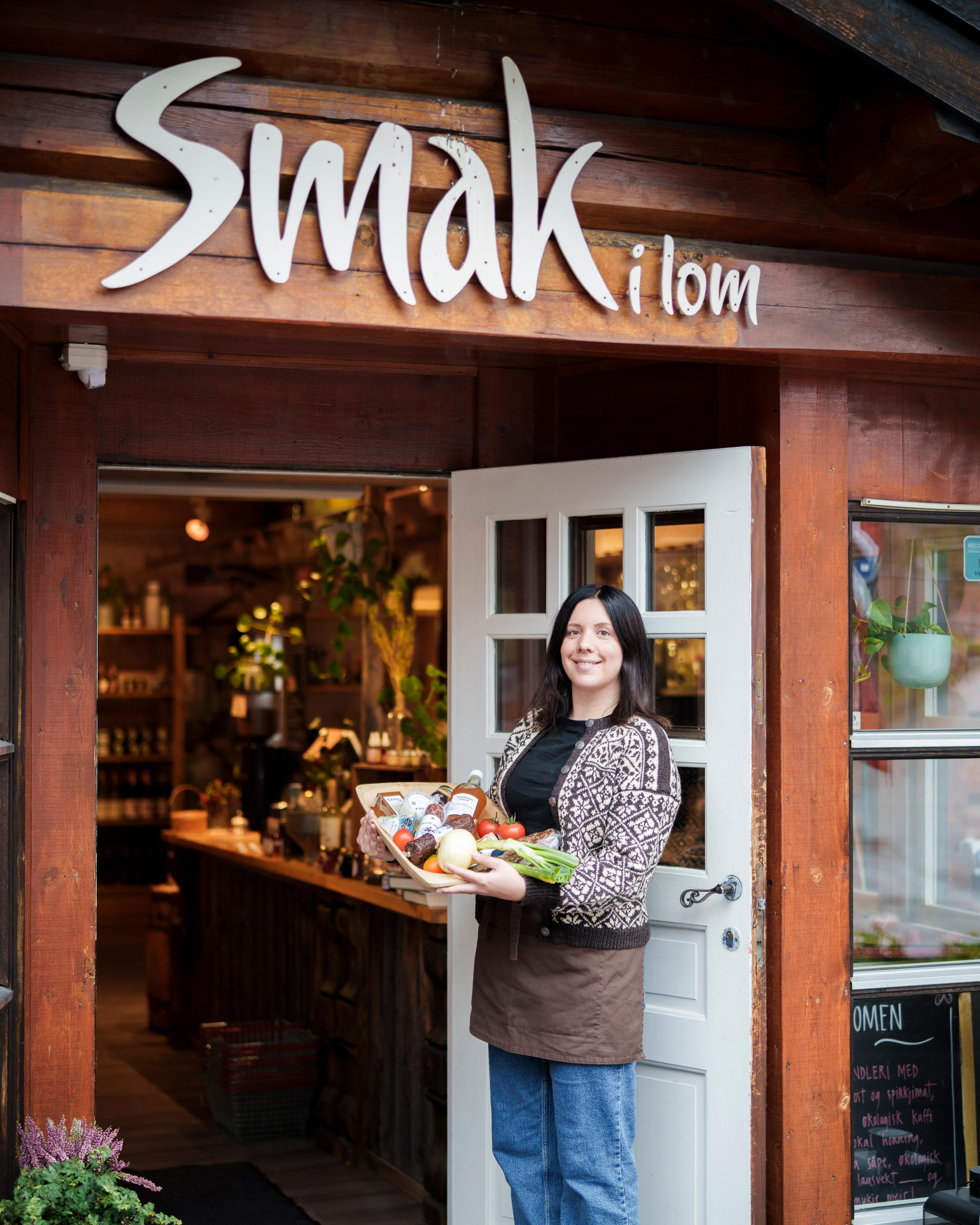 A woman holding a tray with local products.
