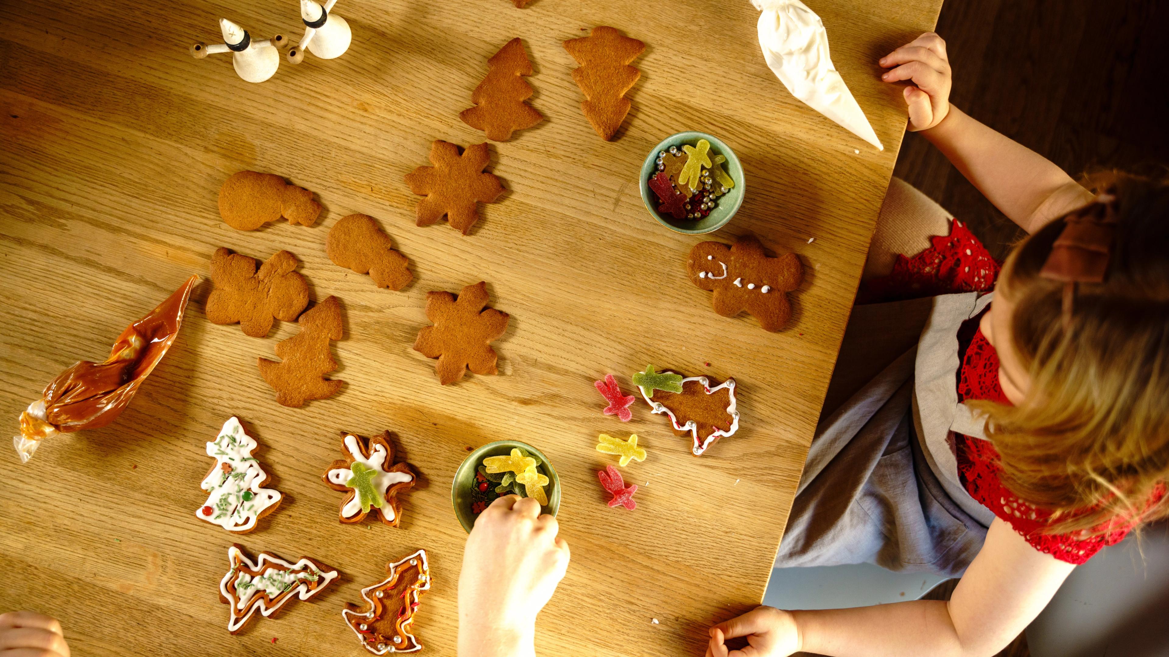 Girl decorating gingerbread cookies