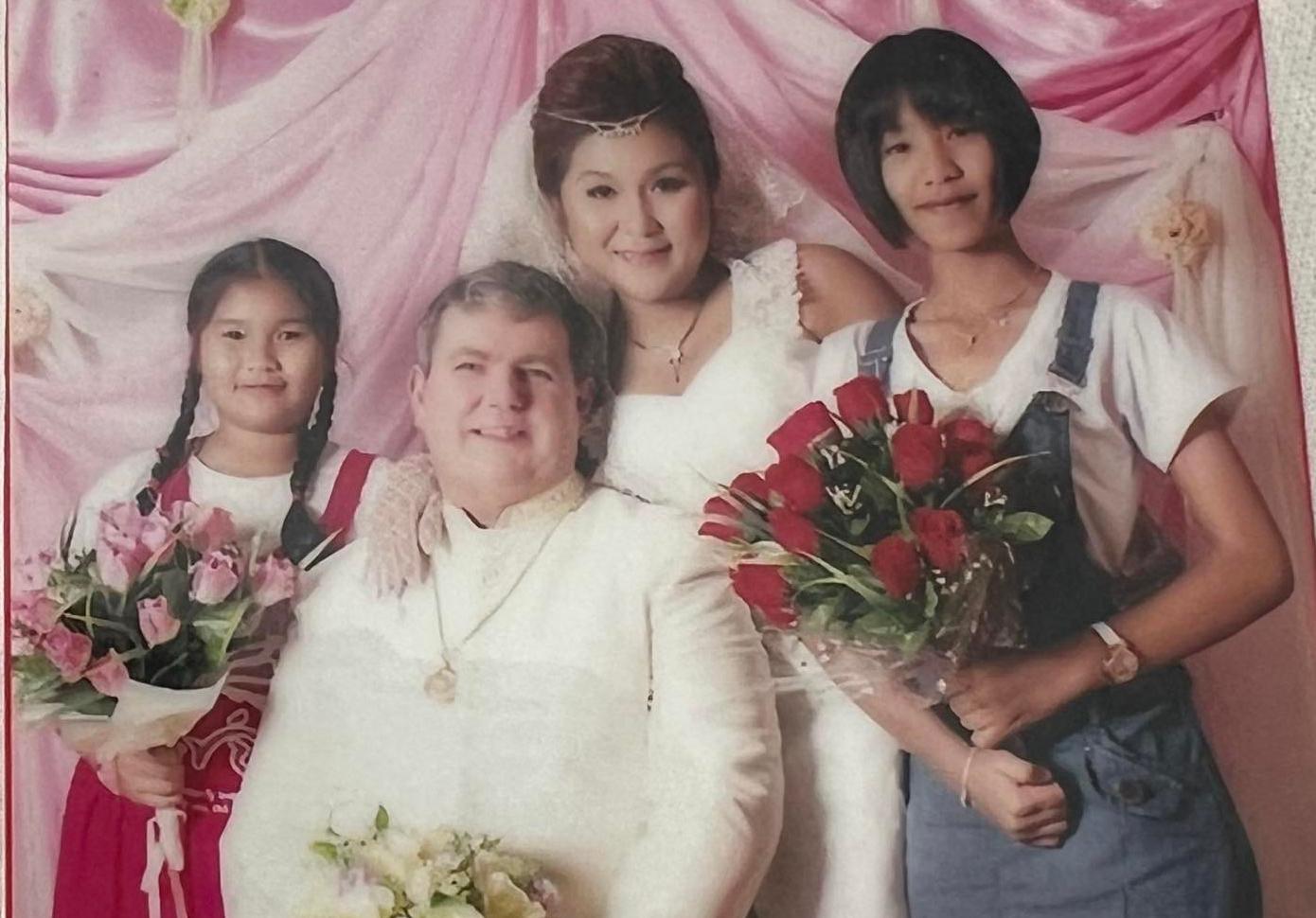 A bride, groom and two children.