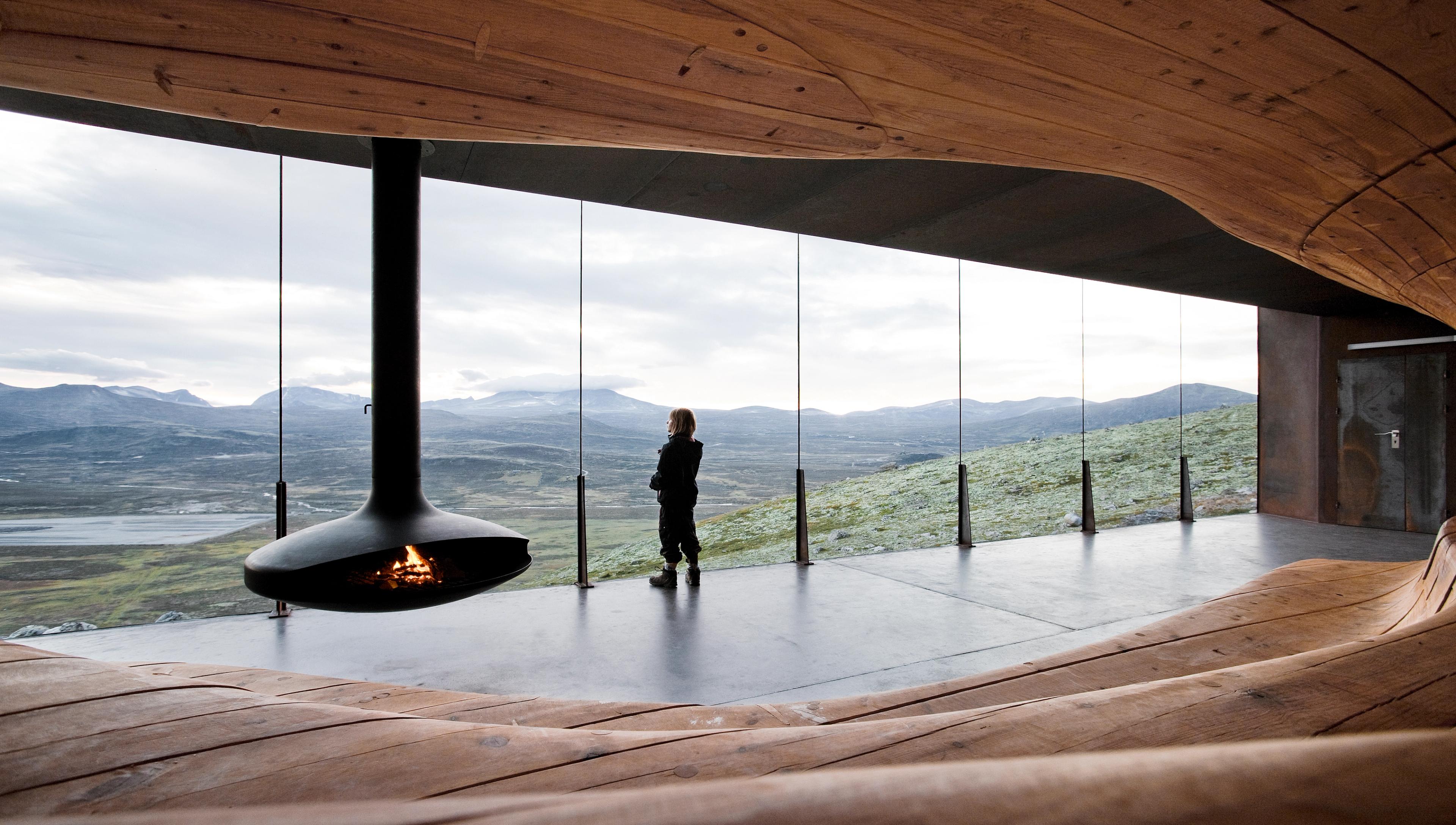 A woman enjoying the view from inside Viewpoint Snøhetta at Dovrefjell, Eastern Norway