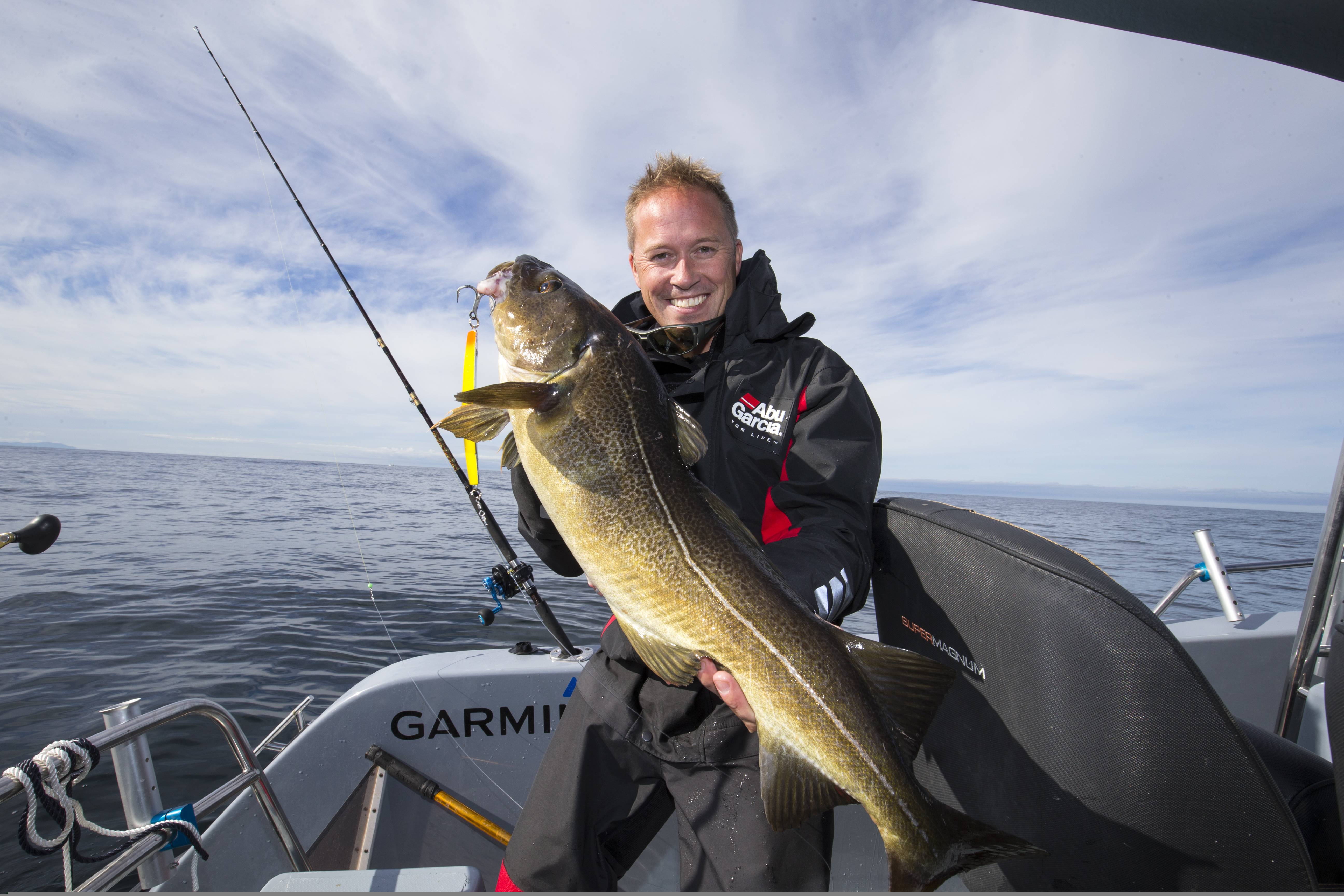 A man showing his big catch from a boat at sea