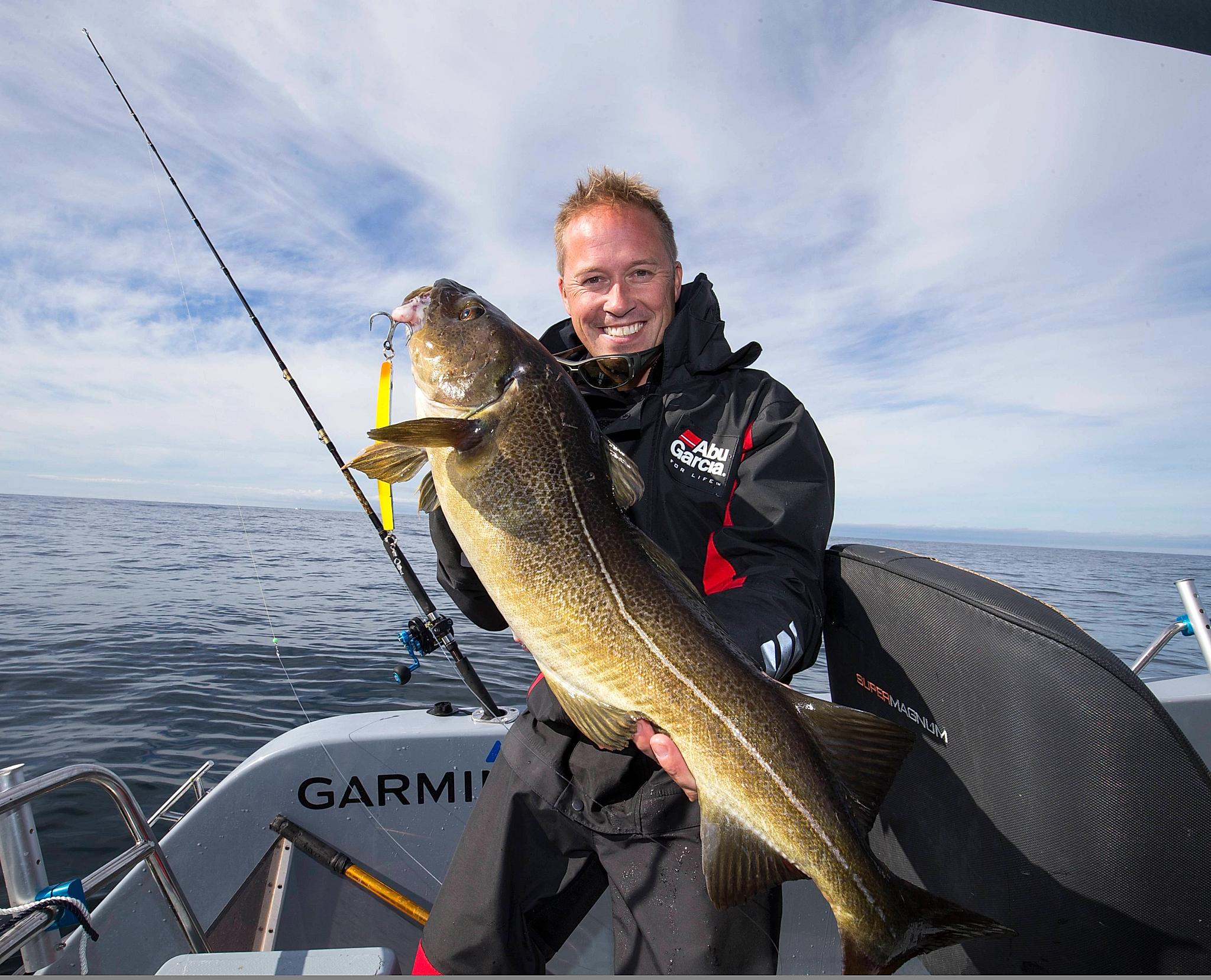 A man showing his big catch from a boat at sea