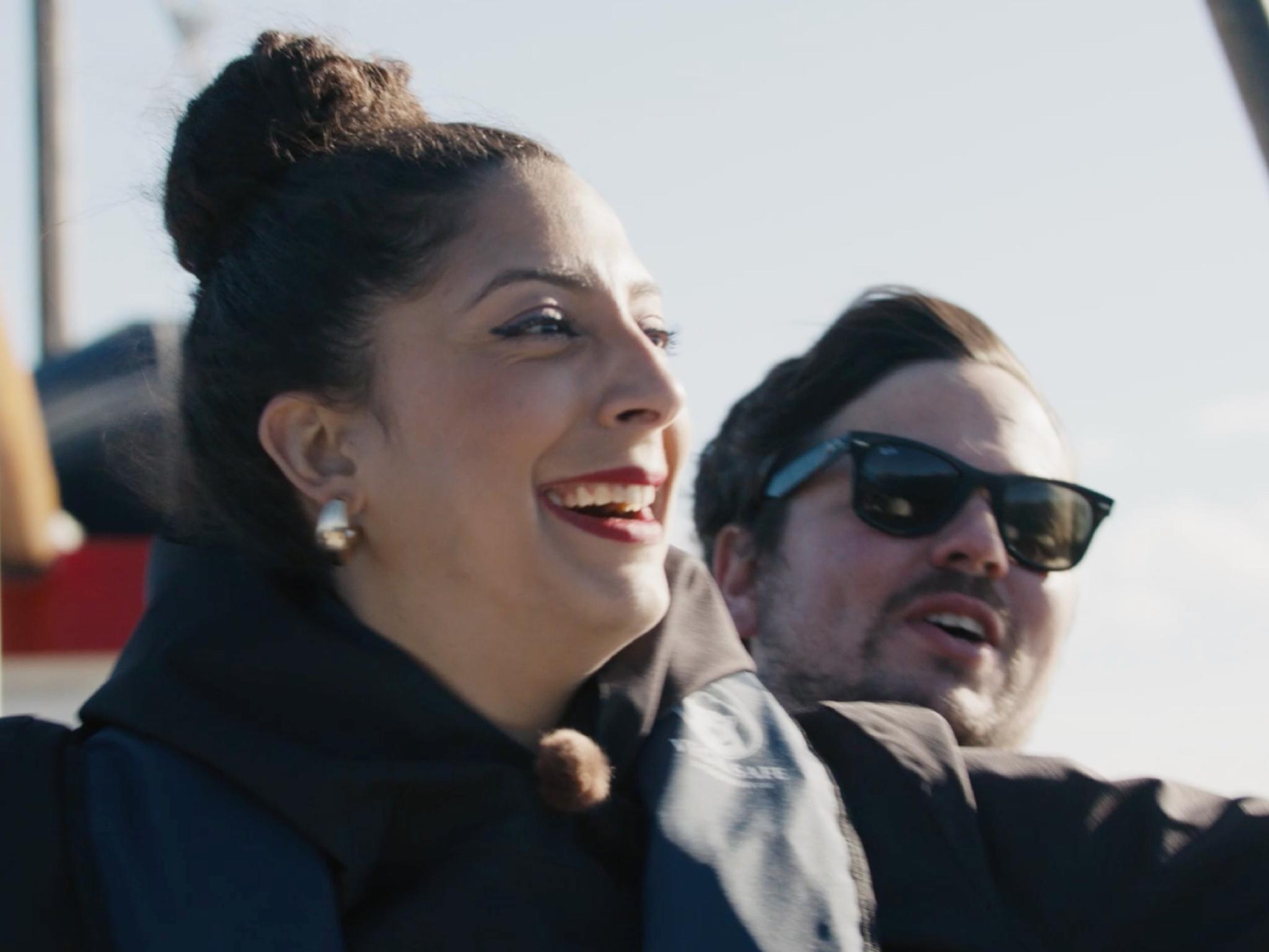 Couple standing on a boat.