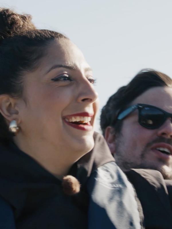 Couple standing on a boat.
