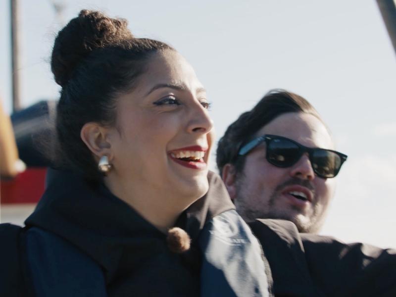 Couple standing on a boat.