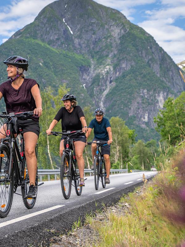 Women cycling along the fjord.