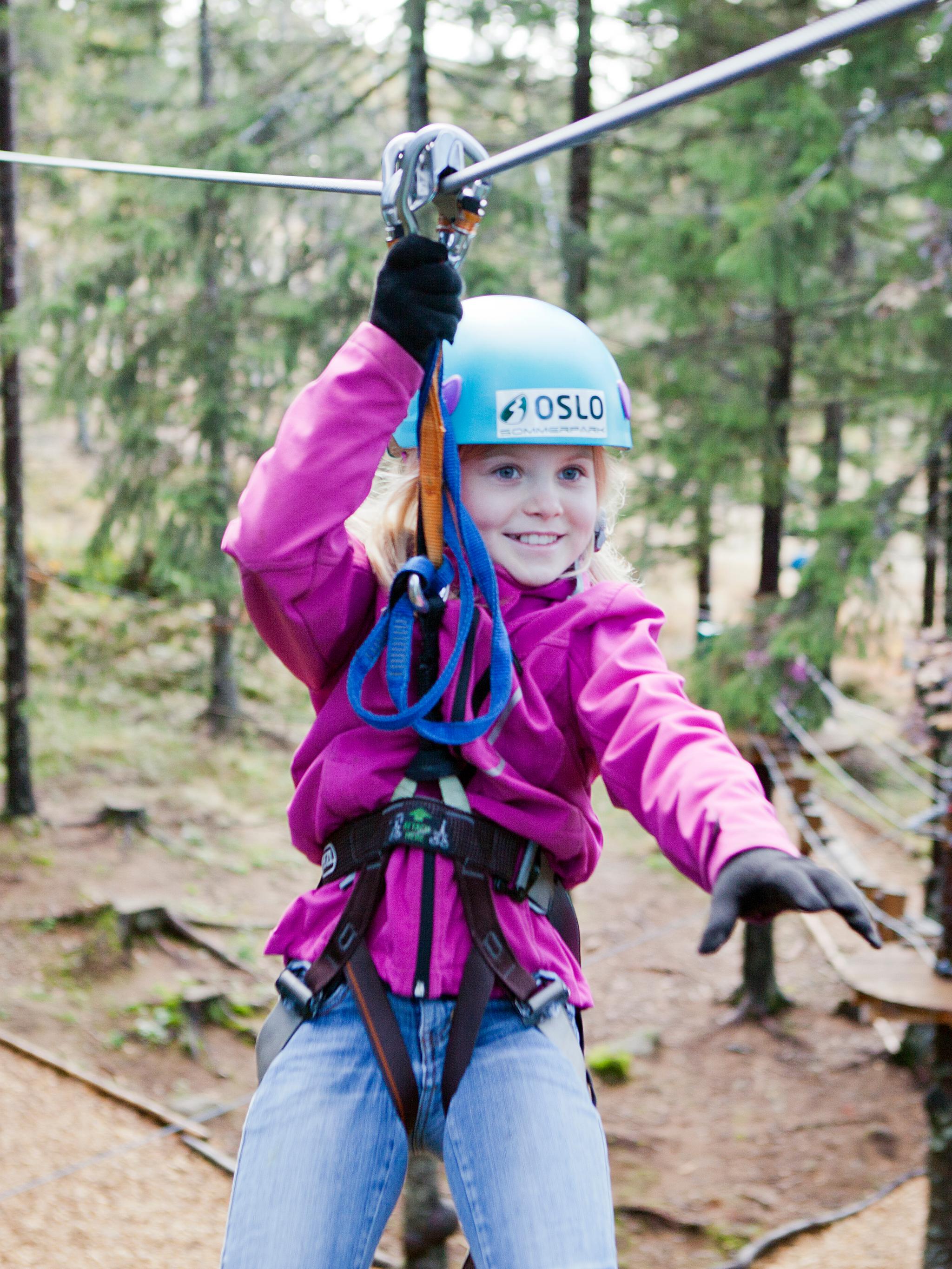 A girl in a zip line in Oslo Sommerpark, Eastern Norway