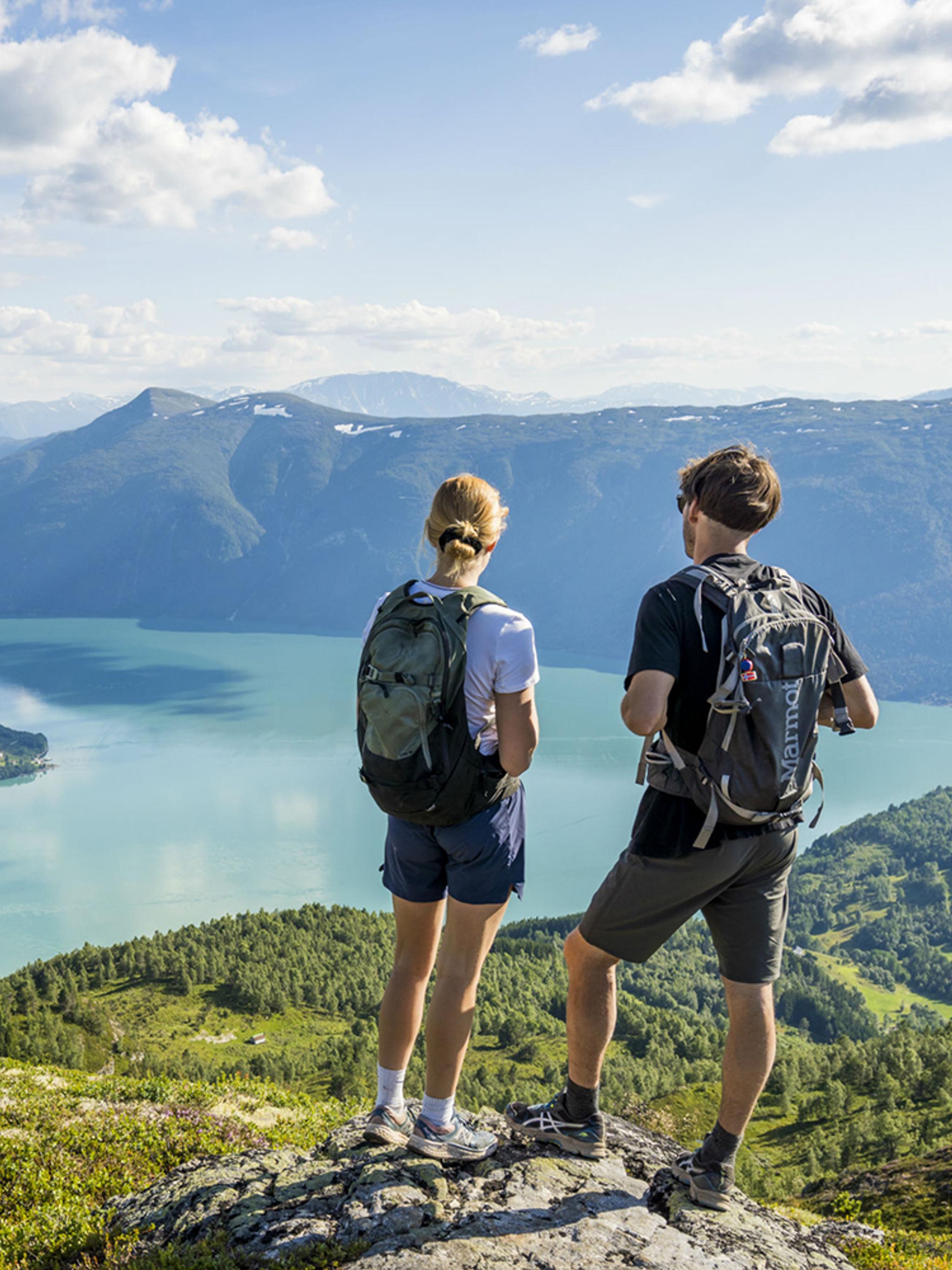 Two people admiring the view from the top of mount Molden in the Sognefjord area of Fjord Norway