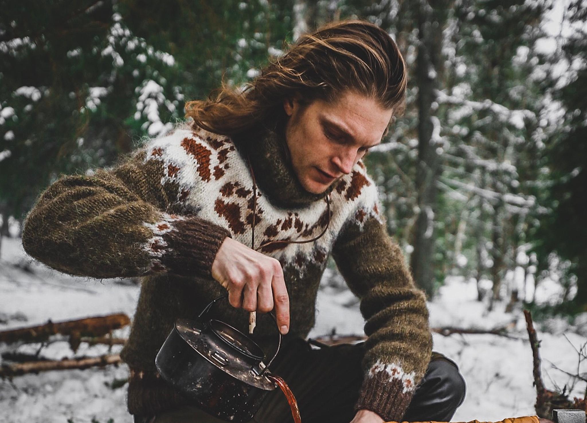 Man in a "villmarksgenser" (wildlife sweater) in the forest.
