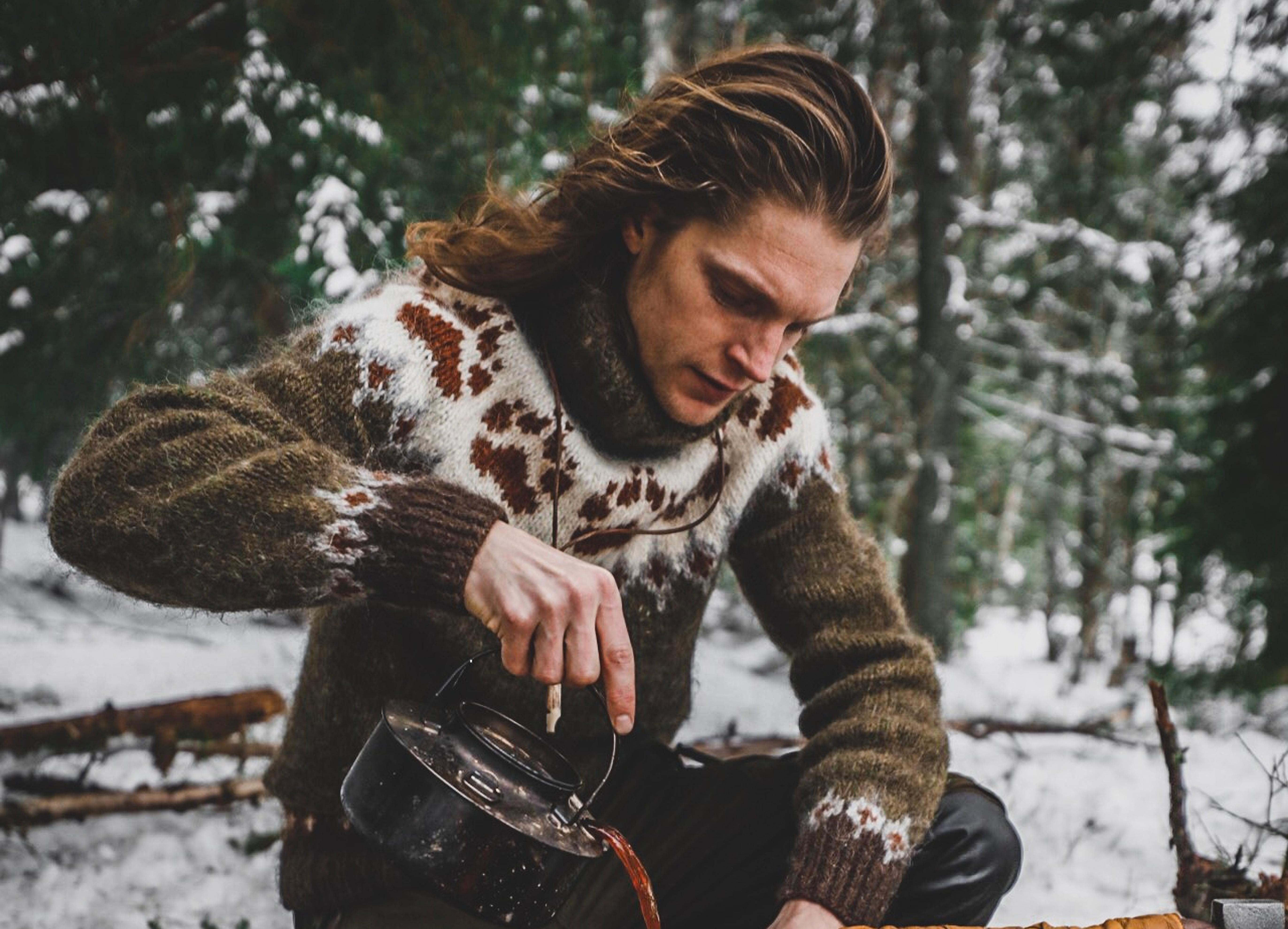 Man in a "villmarksgenser" (wildlife sweater) in the forest.