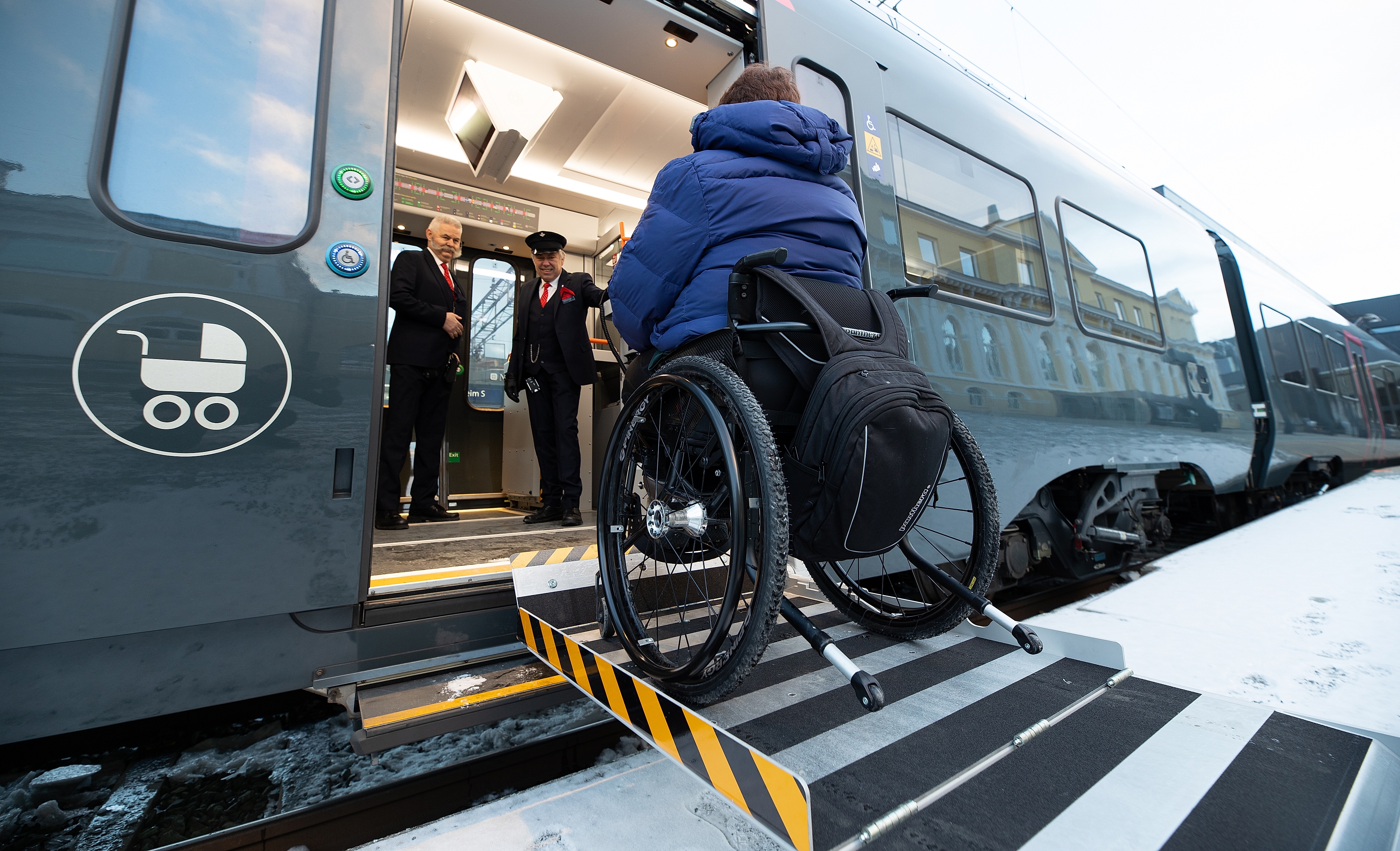 Person in a wheelchair entering a train
