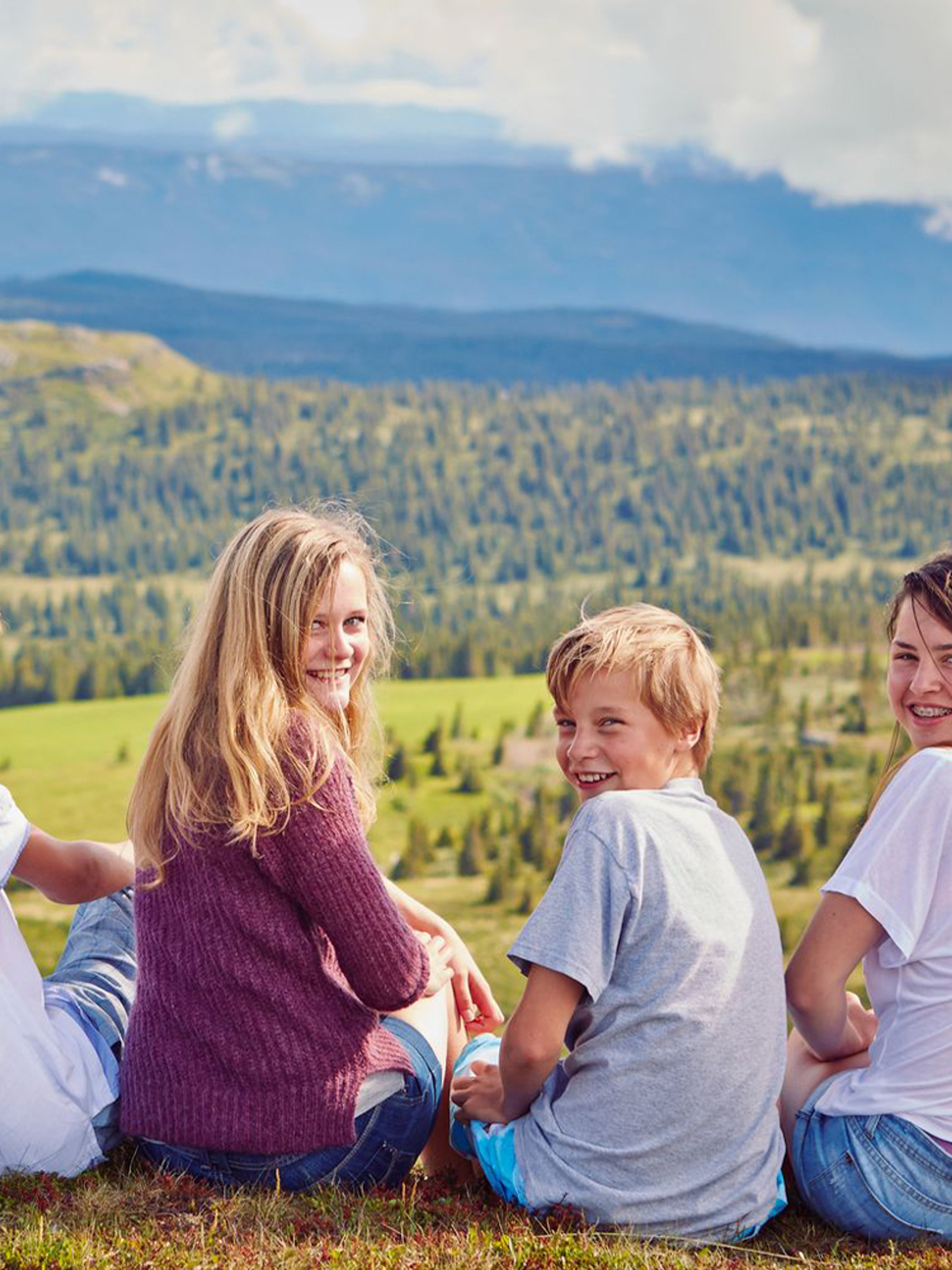 Four kids taking a break on a mountain hike in Gol in Hallingdal, Eastern Norway