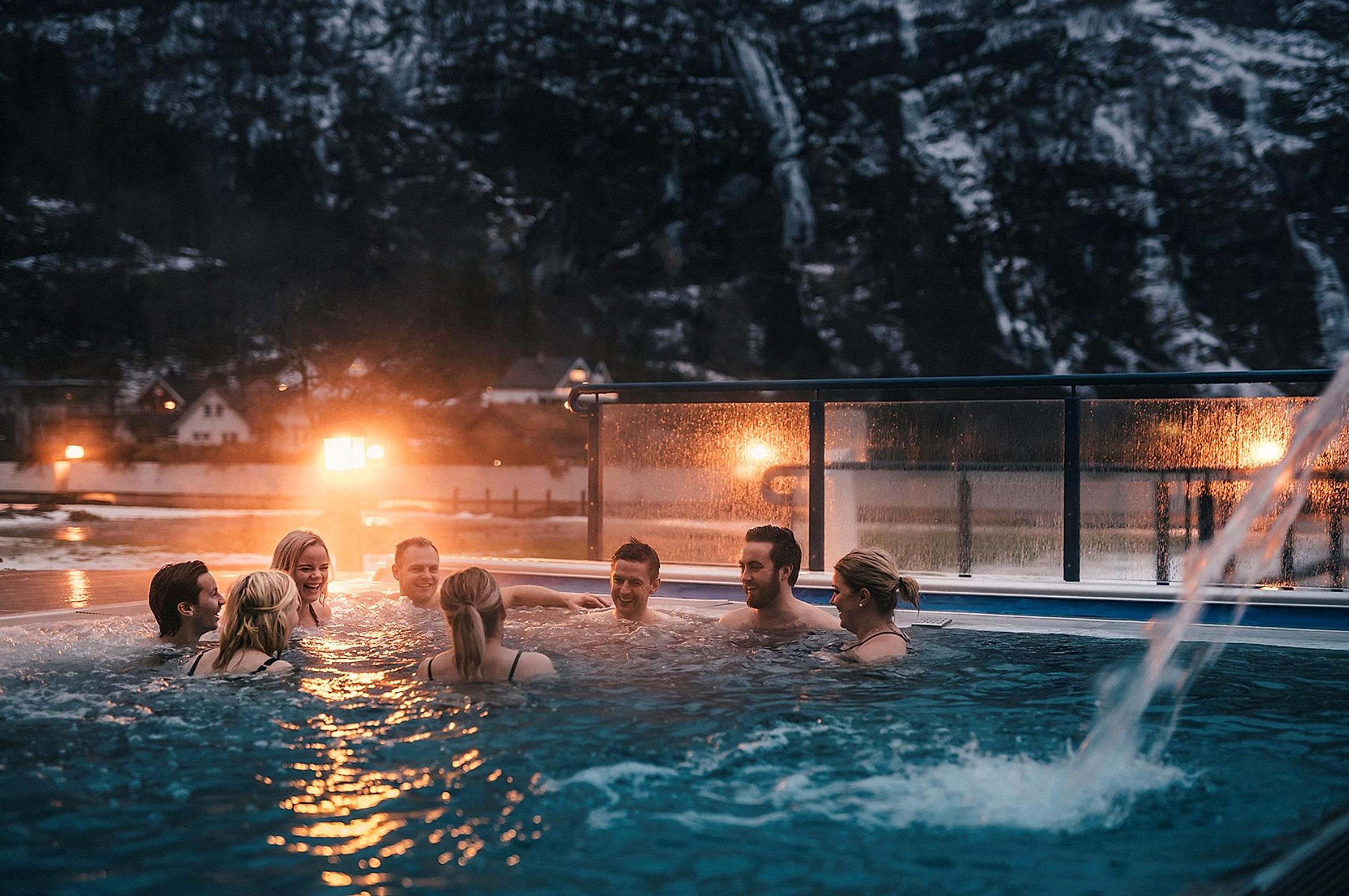 Group of people in an outdoor pool at Hotel Union Bad & Spa, Geiranger, Fjord Norway