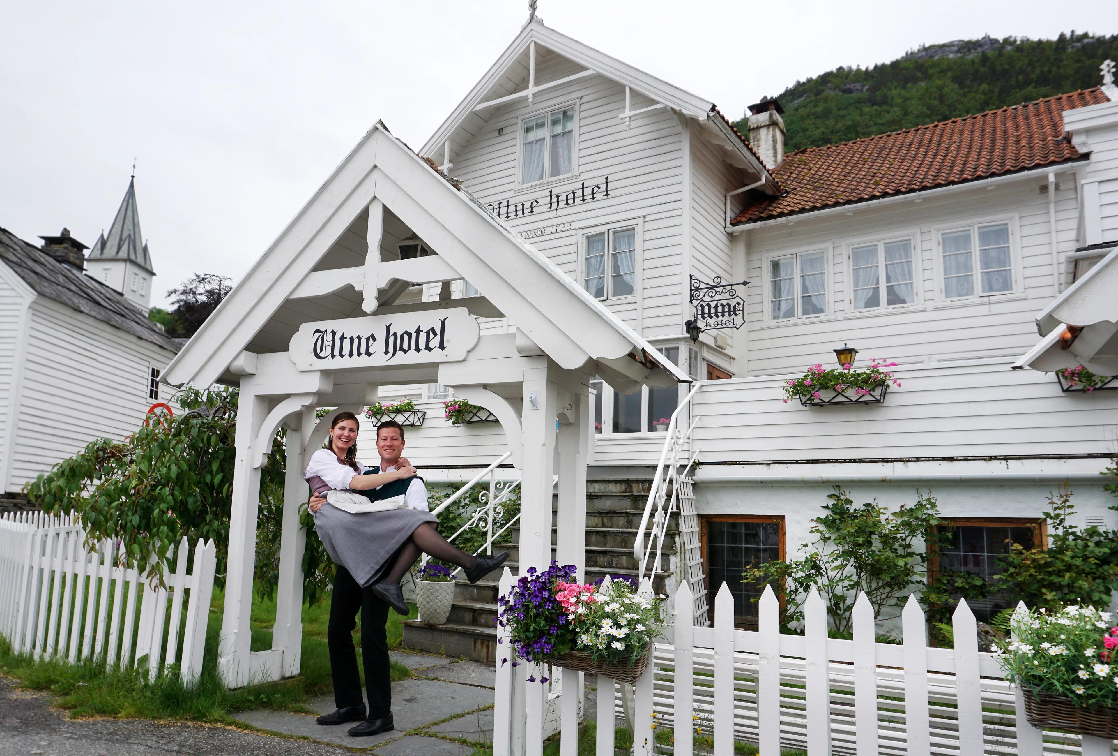 Bente R. och Kjetil Wedding, Utne Hotells ägare, står utanför hotellet i Hardangerfjord i regionen Fjord Norge (Vestlandet)