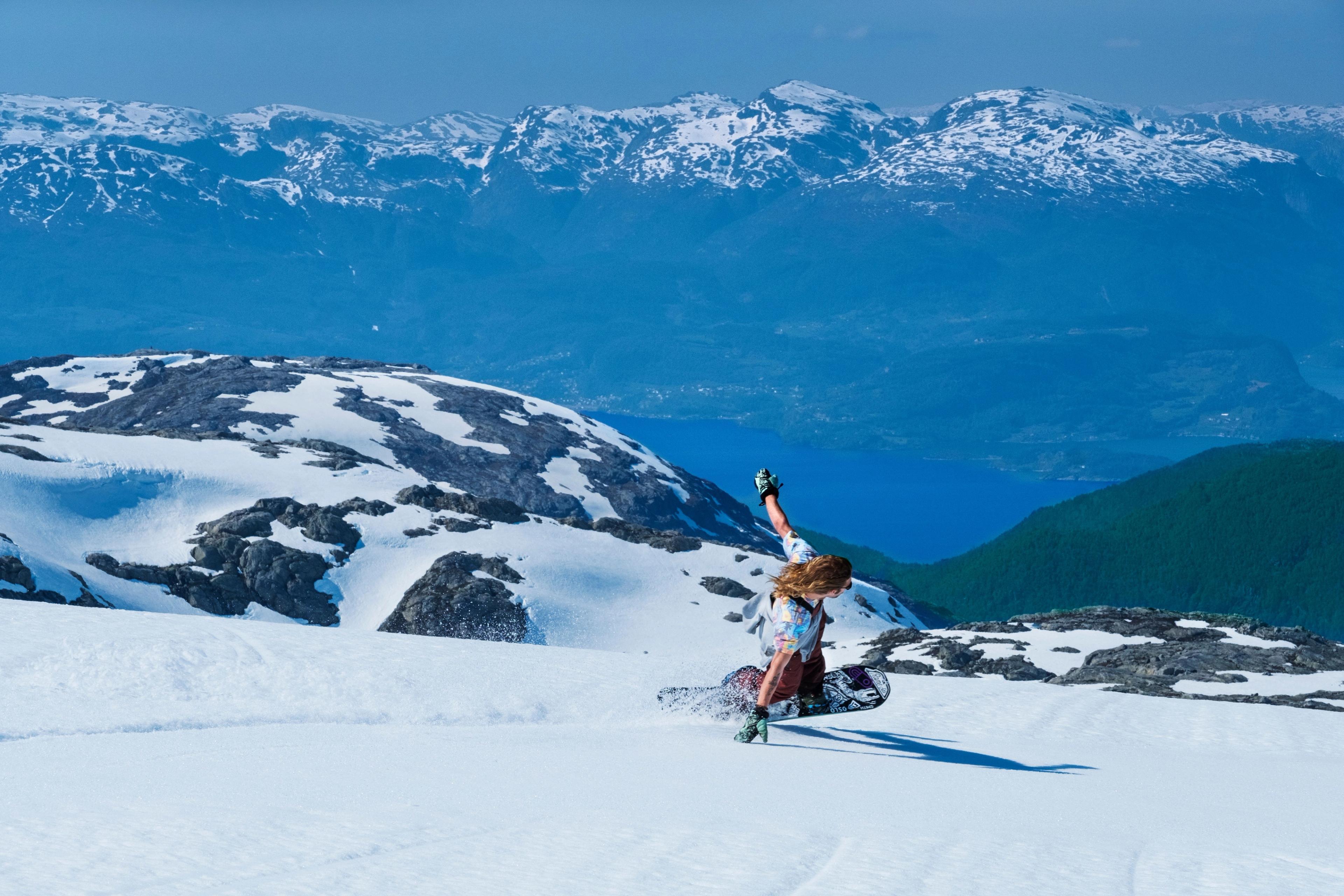 A guy snowboarding at Fonna Glacier Resort in Fjord Norway