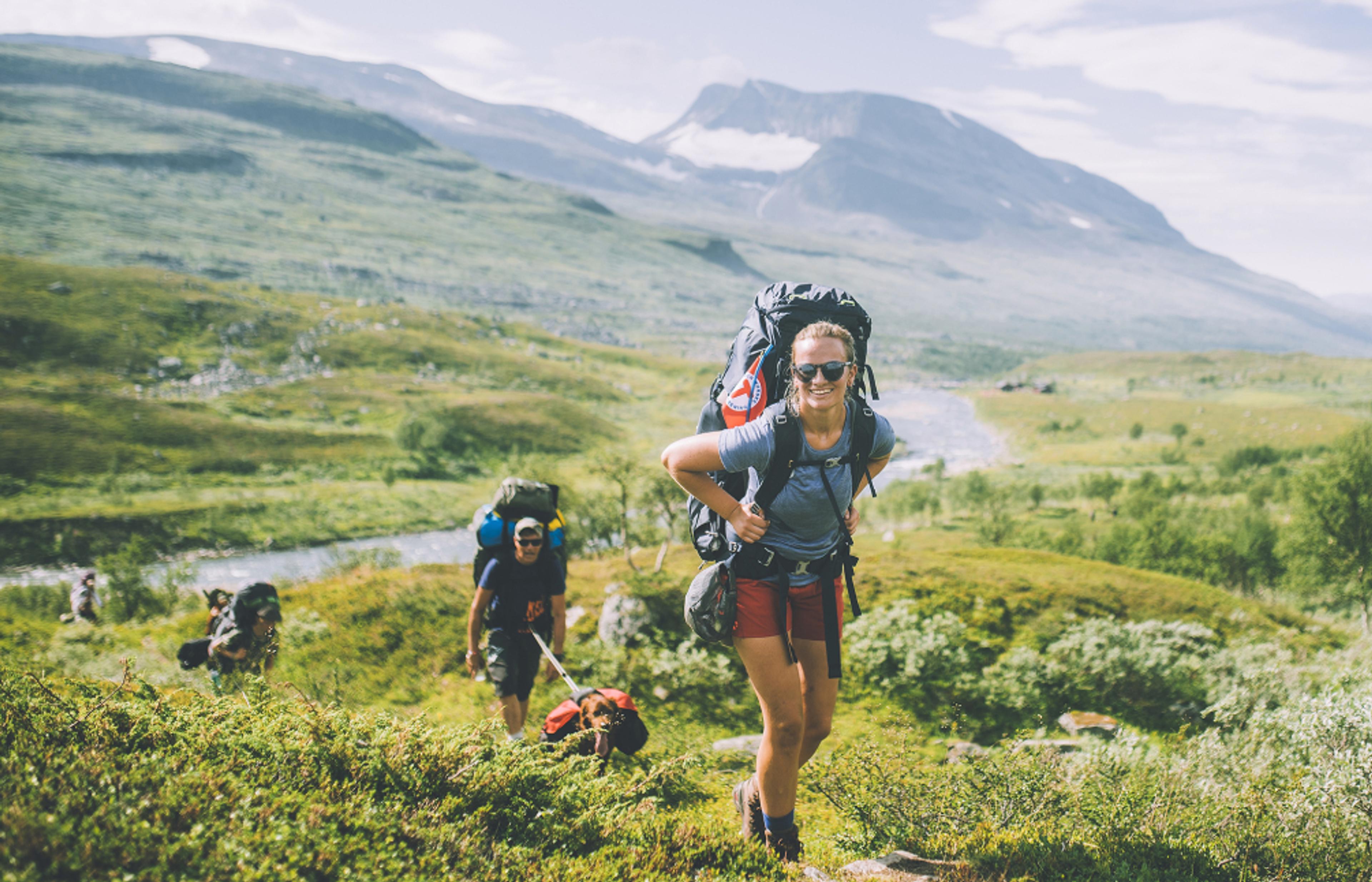 People summer hiking in mountainous landscape in Indre Troms, Northern Norway