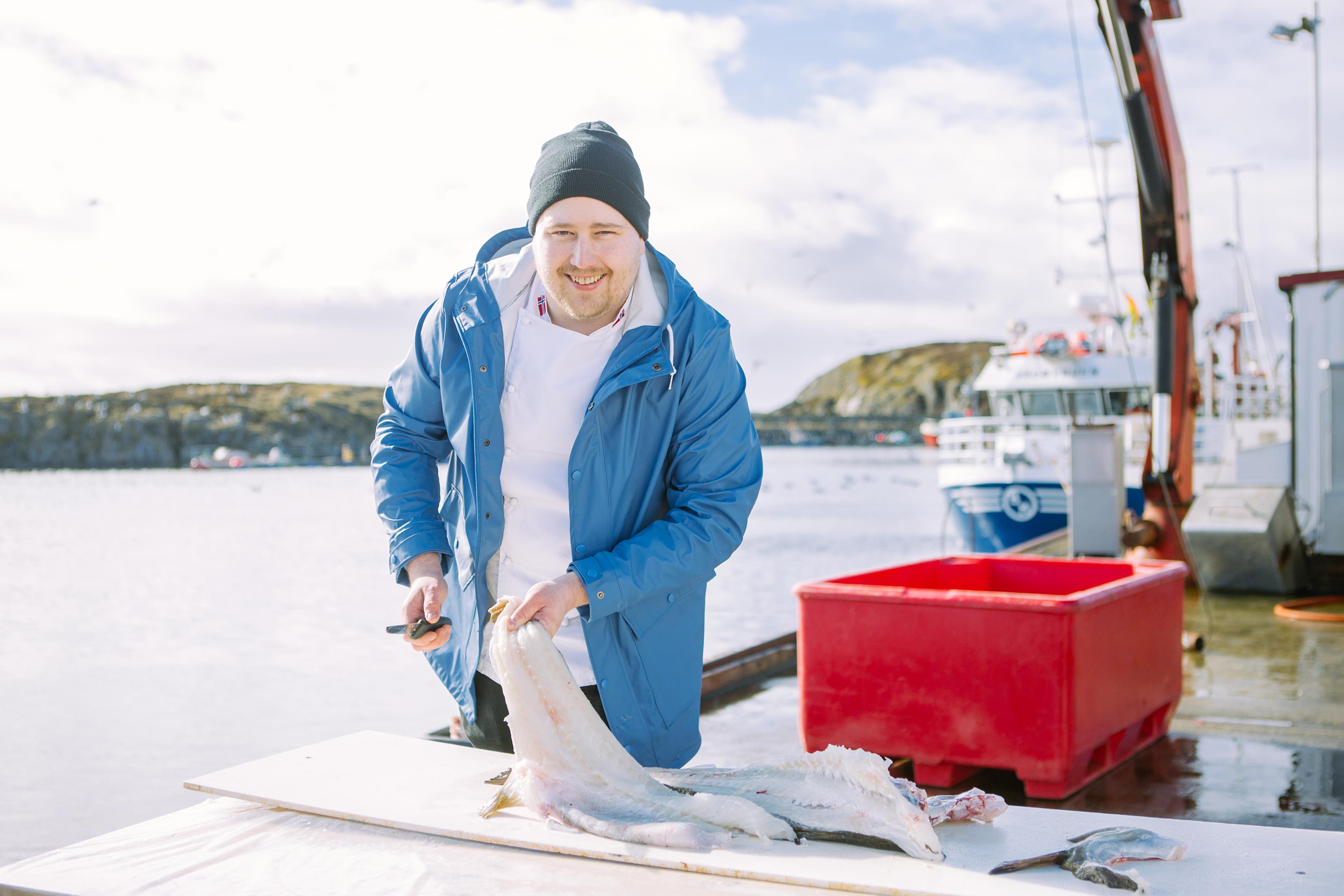 A man with a freshly caught skrei at "Skreifestivalen" festival in Rørvik